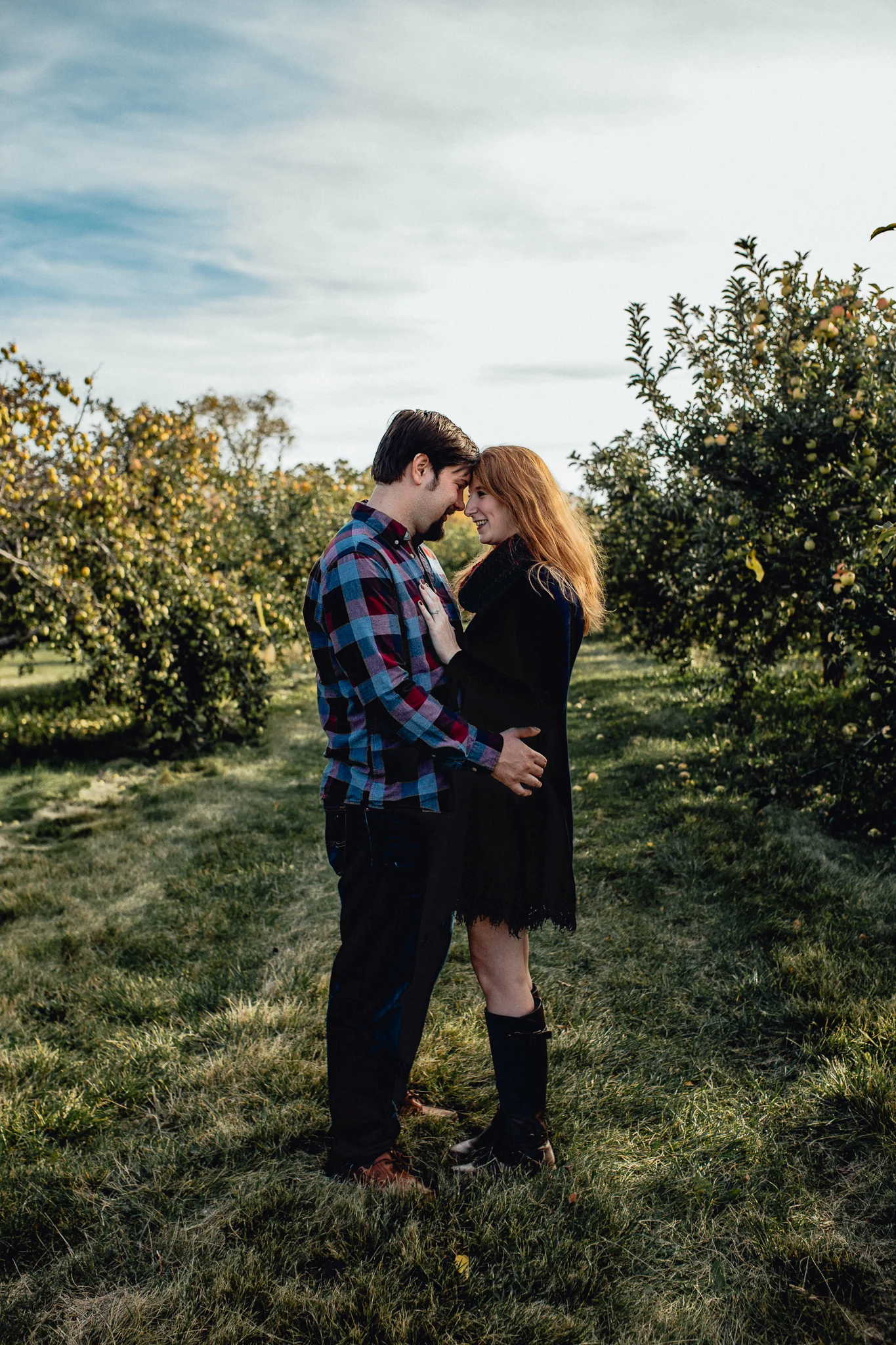 ENGAGEd-couple-kissing-in-apple-orchard.jpg