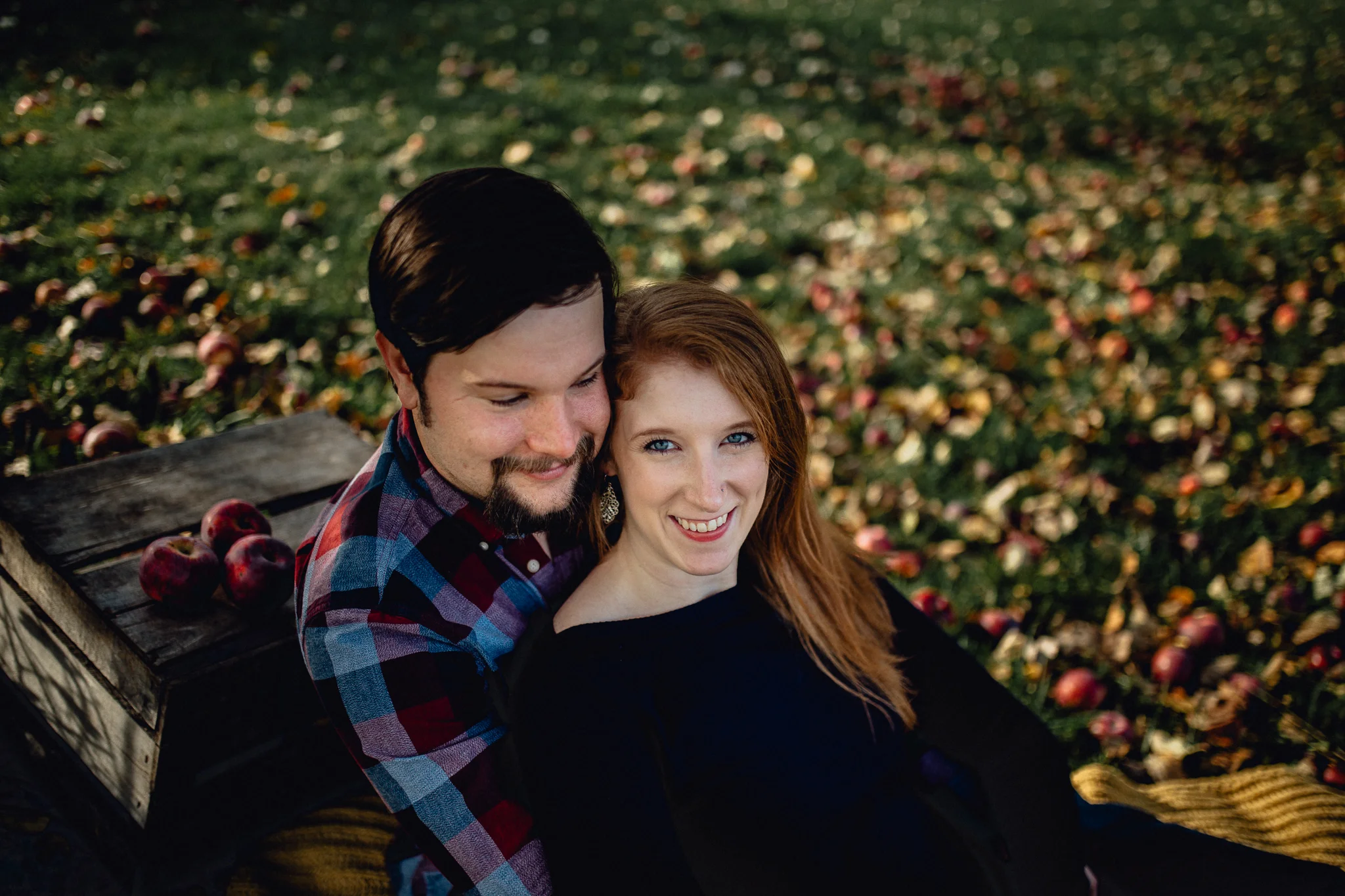 ENGAGEd-couple-posing-in-apple-orchard.jpg