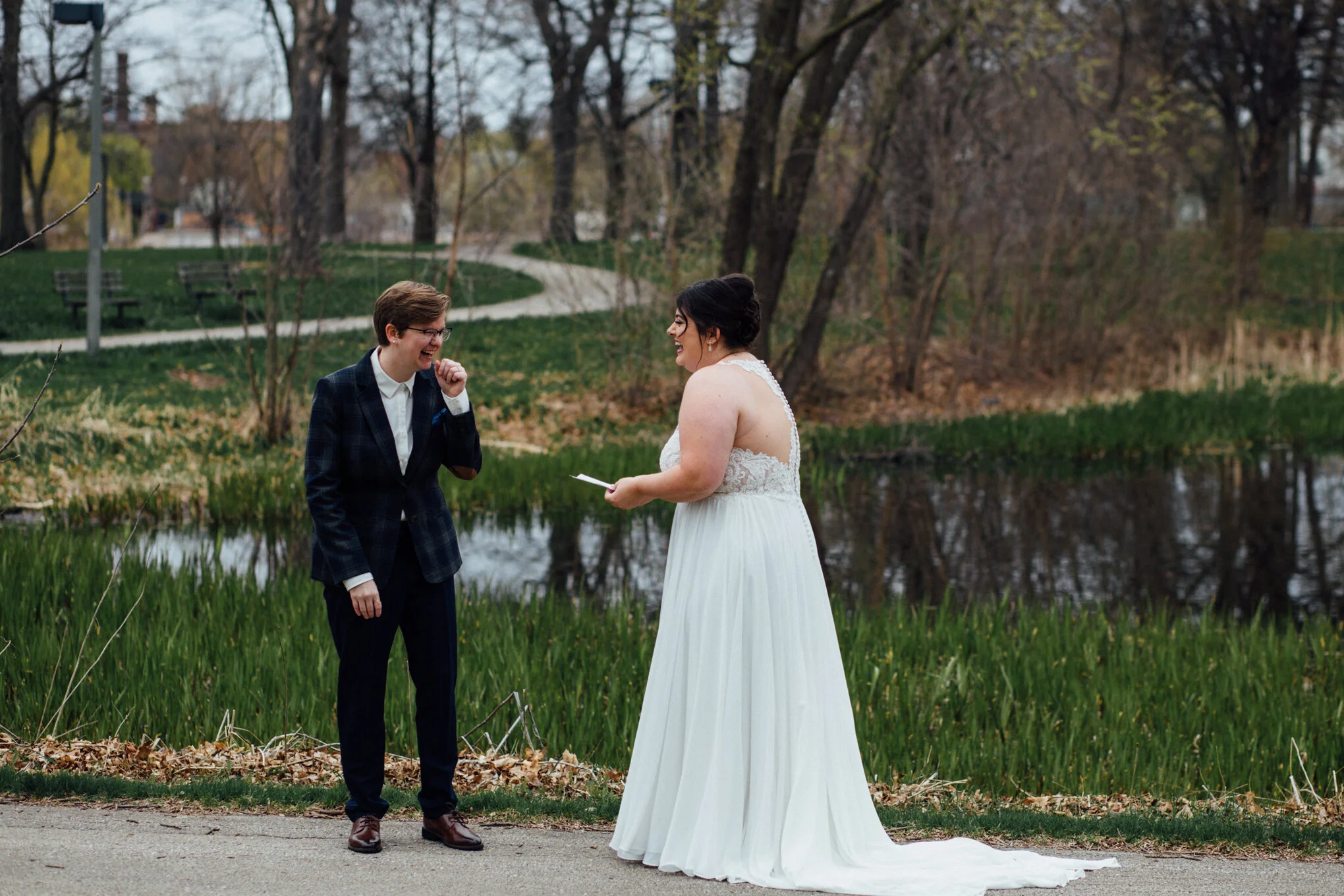 brides-laughing-exchanging-vows-during-first-look-at-humboldt-park.jpg