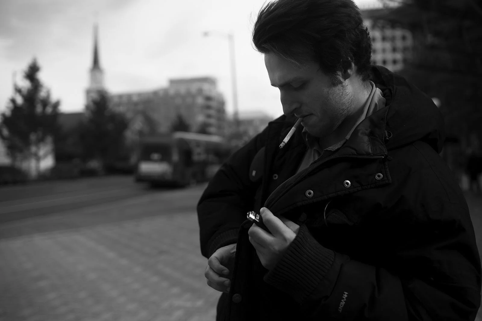 Patrick Kenyon, 24, smoking a cigarette Nov. 19 before panhandling at the Ballston Metro station in Washington D.C.. If someone is panhandling when he arrives, he travels to Tysons Corner.
