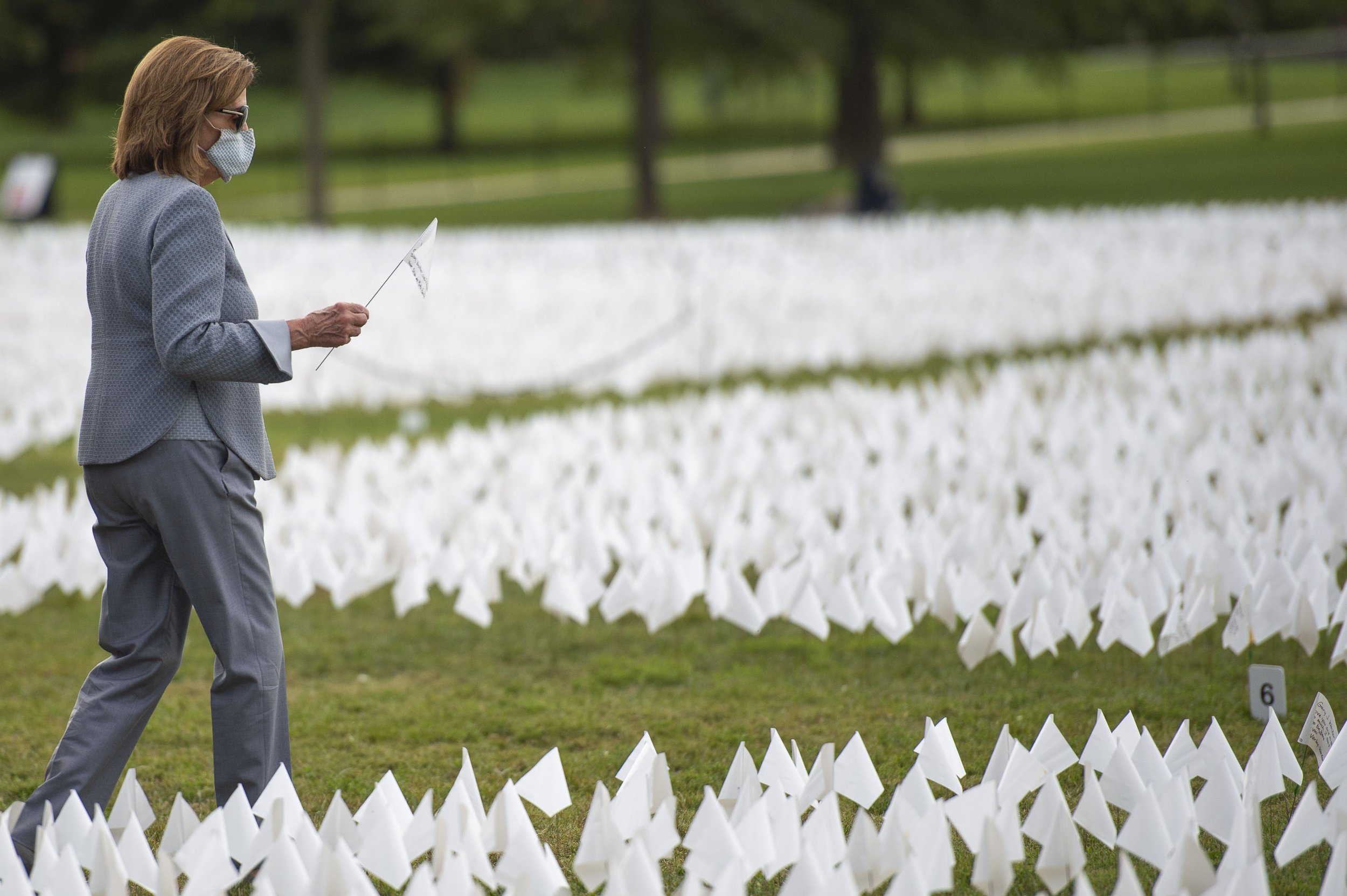  Speaker of the House Nancy Pelosi visits "In America: Remember" a public art installation by artist Suzanne Firstenberg on Tuesday, September. 21, 2021. The exhibit features more than 600,000 white flags, each representing one life lost due to COVID