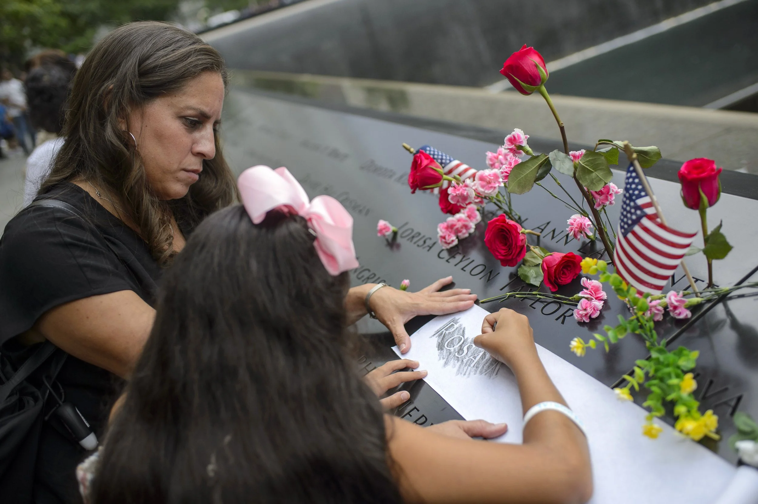  People gather at the National September 11th Memorial to commemorate the 21st anniversary of the attacks on the World Trade Center in New York City on Sunday, September 11, 2022.  