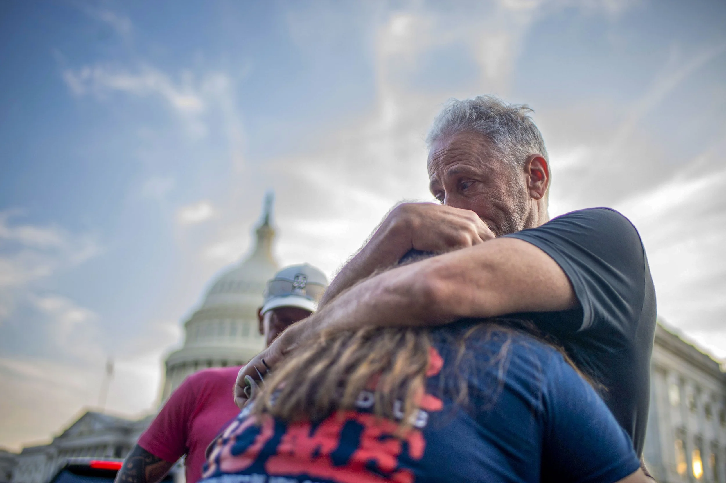  Activist and Comedian Jon Stewart, and other members of veterans-rights groups, embrace after the Senate passed the PACT Act, a bill to expand health care benefits for veterans exposed to toxic burn pits, on Tuesday, August 2, 2022 