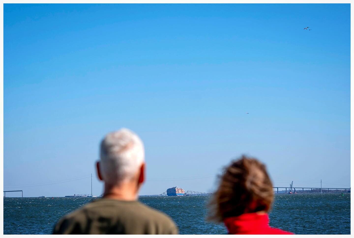 A couple views the Dali cargo ship and the wreckage of The Francis Scott Key Bridge from Fort McHenry in Baltimore, Maryland. @upi