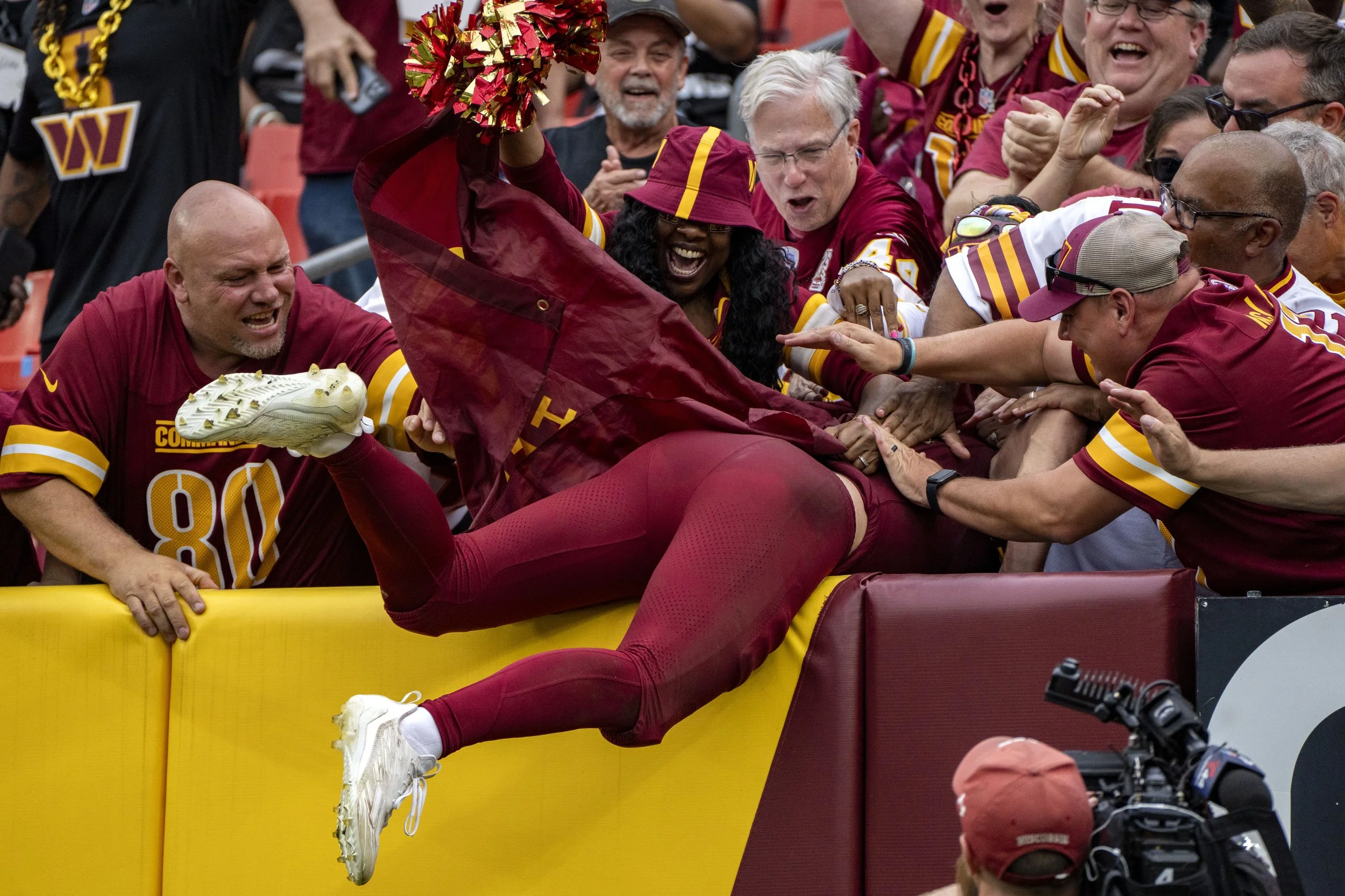  Washington Commanders wide receiver Luke McCaffrey (11) jumps into the crowd after scoring a touchdown during the fourth quarter of a game against the Las Vegas Raiders at Northwest Stadium in Landover, Maryland on Sunday, September 21, 2025 