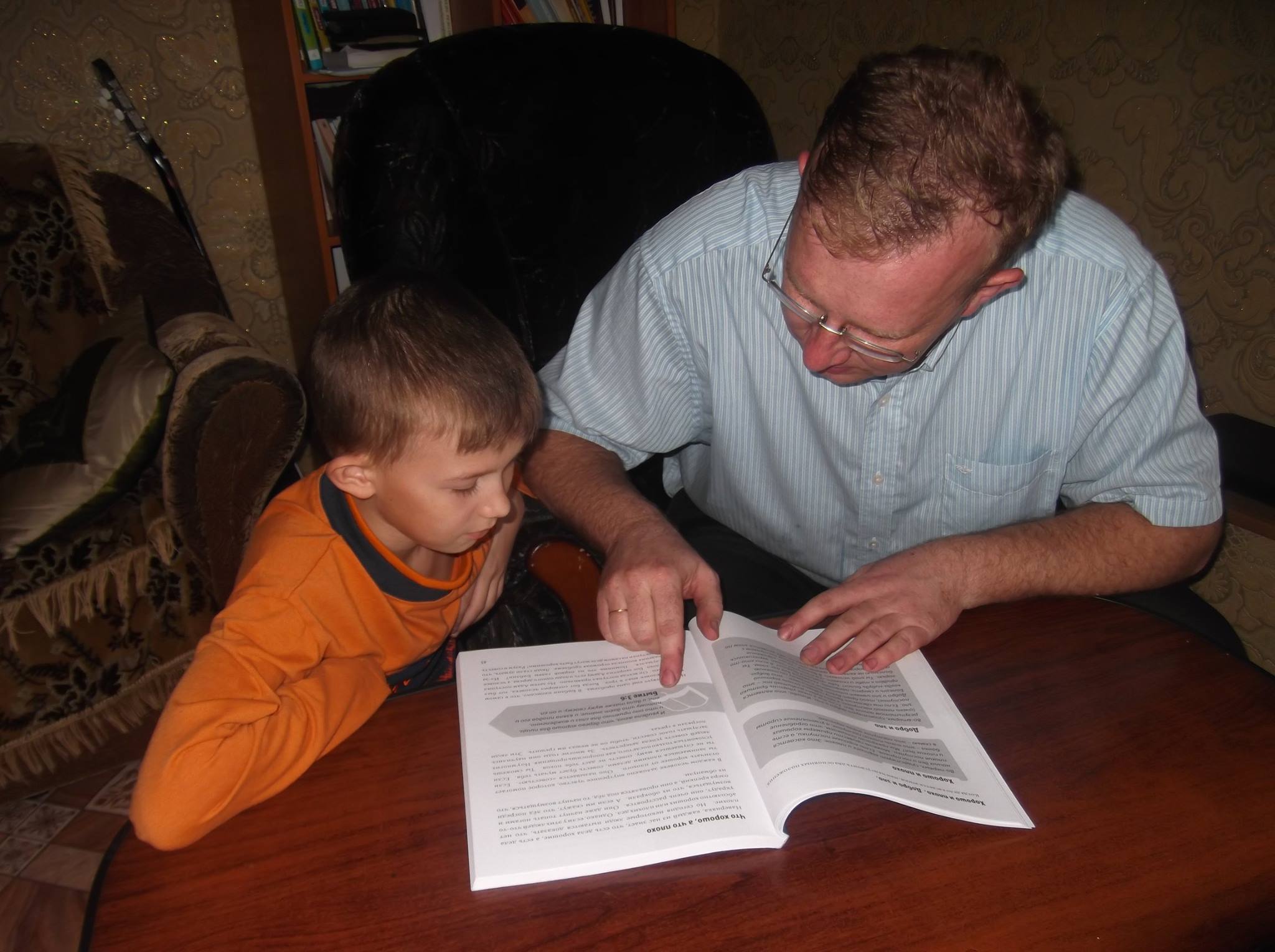 Jhenya helps his son Slava to gain an understanding of a new subject.