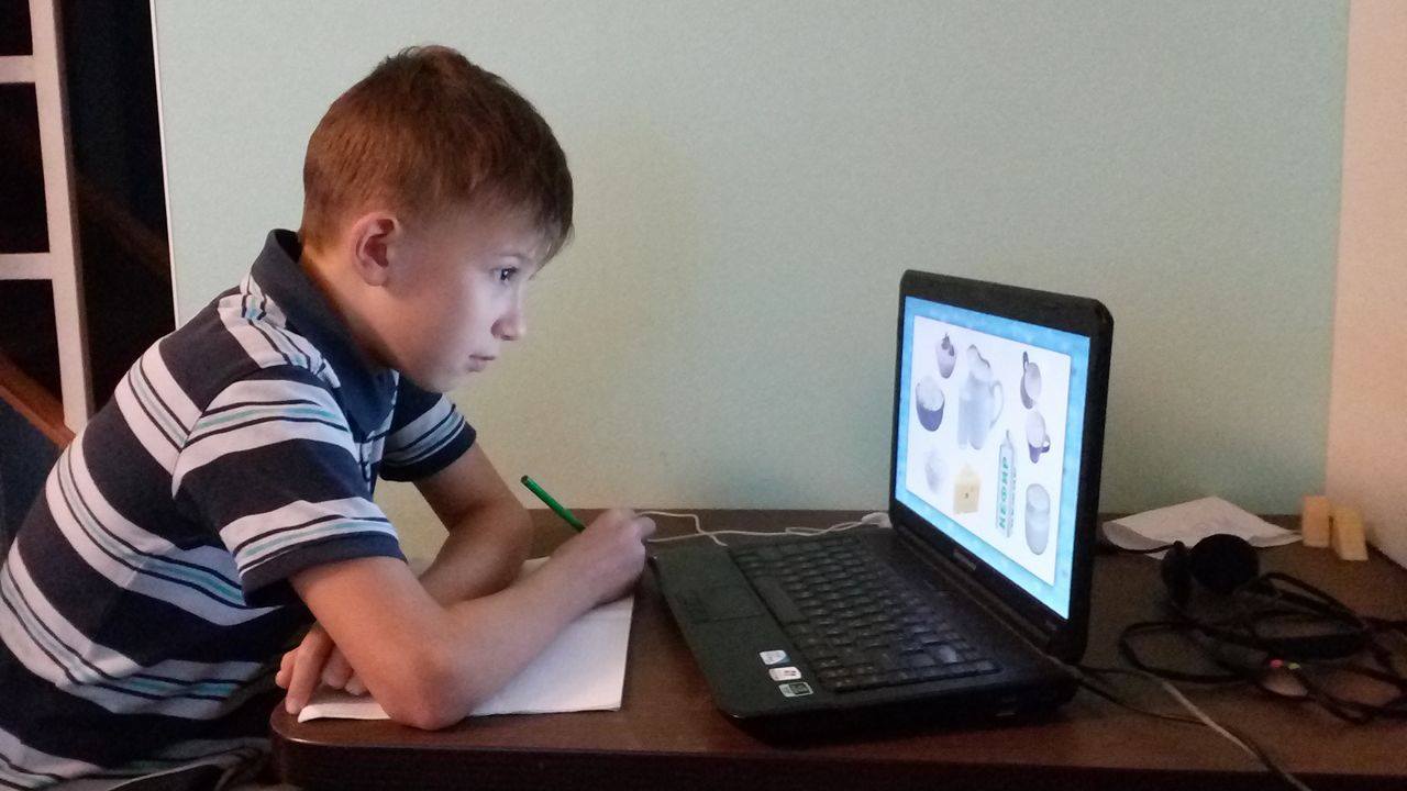 Slava learns to use the online program for homeschooling.