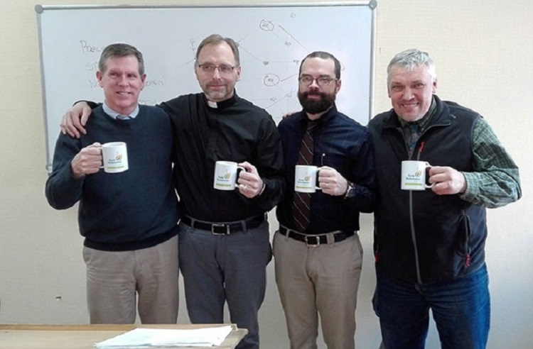 Visiting professors and Oleg Volkov with SRS mugs.