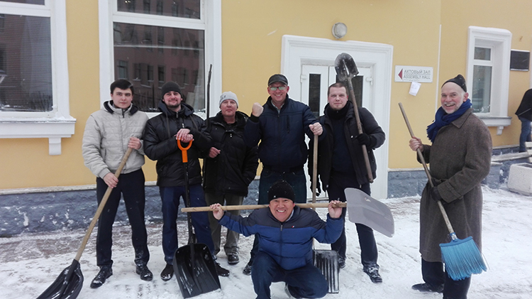 Seminary students and Blake Purcell cleaning the area near the Christian University.