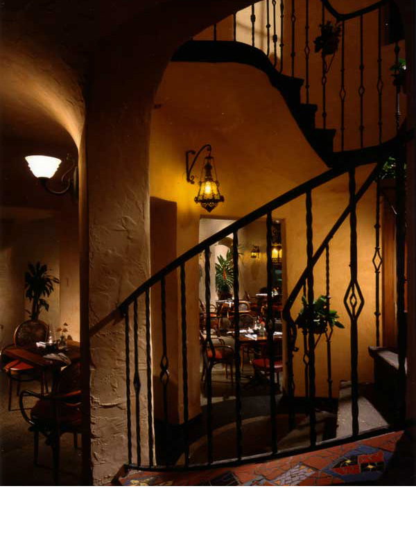  Existing iron staircase railings were complemented with antique Mexican sconce lights and mosaic tile. 