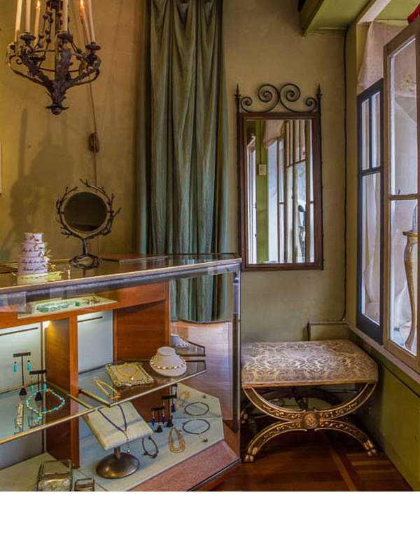 Old windows were hung behind window displays as backing to allow the interior shop more light.