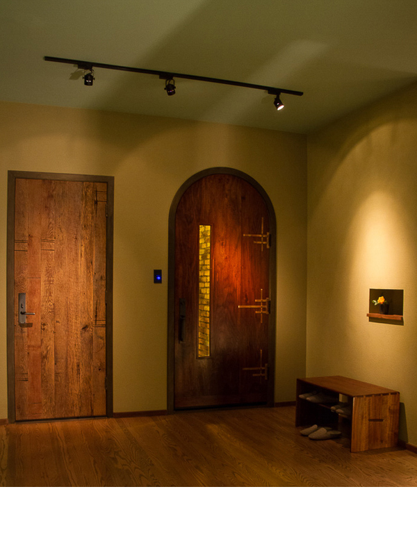  Old oak planks were used in contrast to the remake of an arched door for this new entry to the garage. 