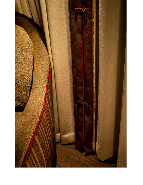  Red inserts in curtains complement red walls and cabinets in the room. 