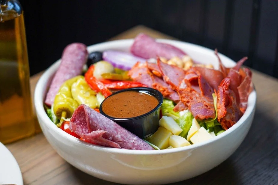 Dive into a flavorful antipasto salad brimming with fresh ingredients and savory delights.

#FirstAndLastTavernPlainville #ExplorePlainville #BarAndRestaurant #AntipastoSalad #HeartyEats #BarAndGrill