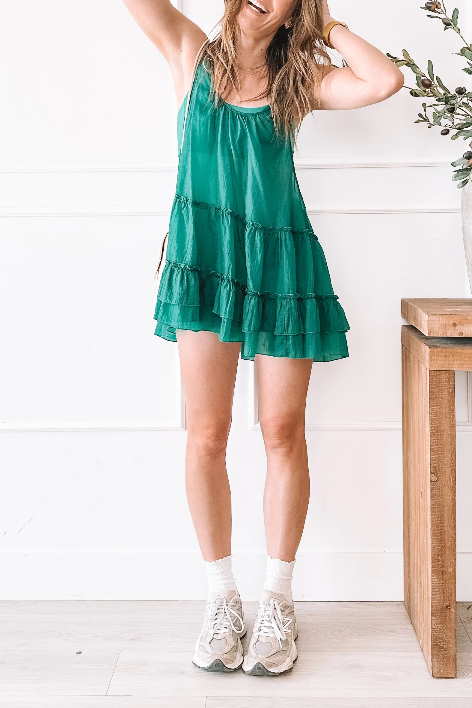 green tiered mini dress with sneakers everyday outfit idea