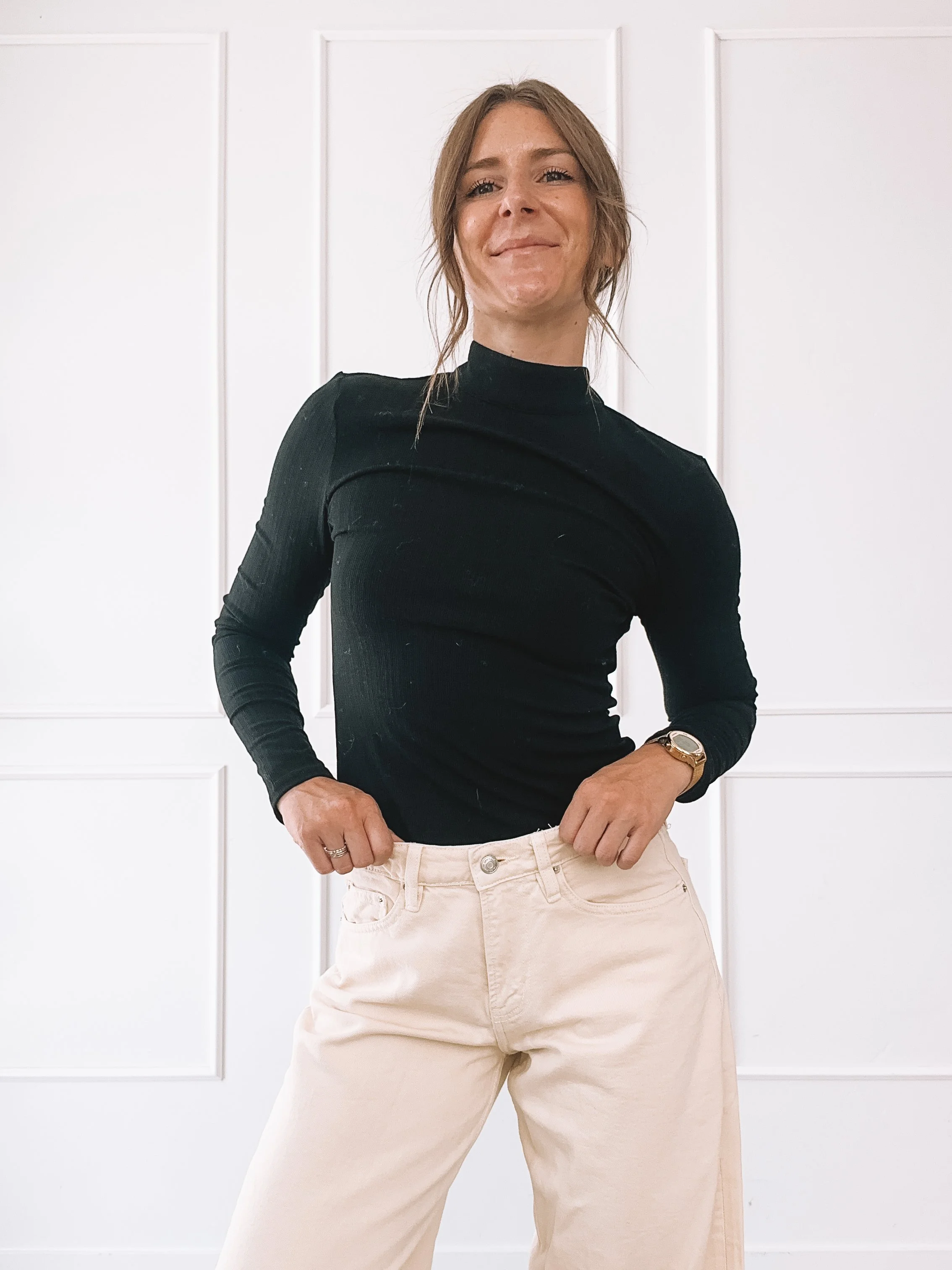 Black cutout top and cream wide leg jeans fall outfit