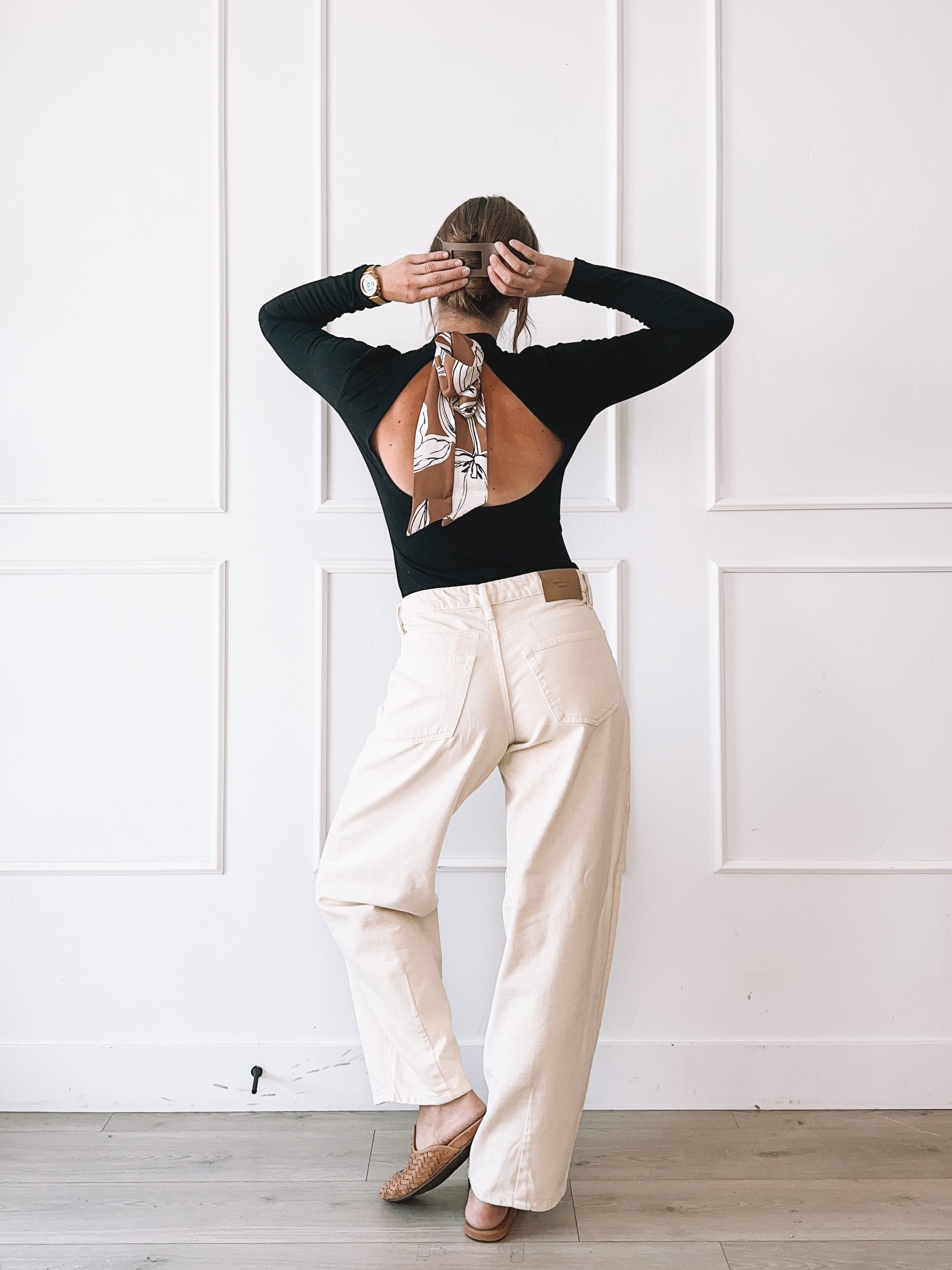 Black cutout top and cream wide leg jeans fall outfit