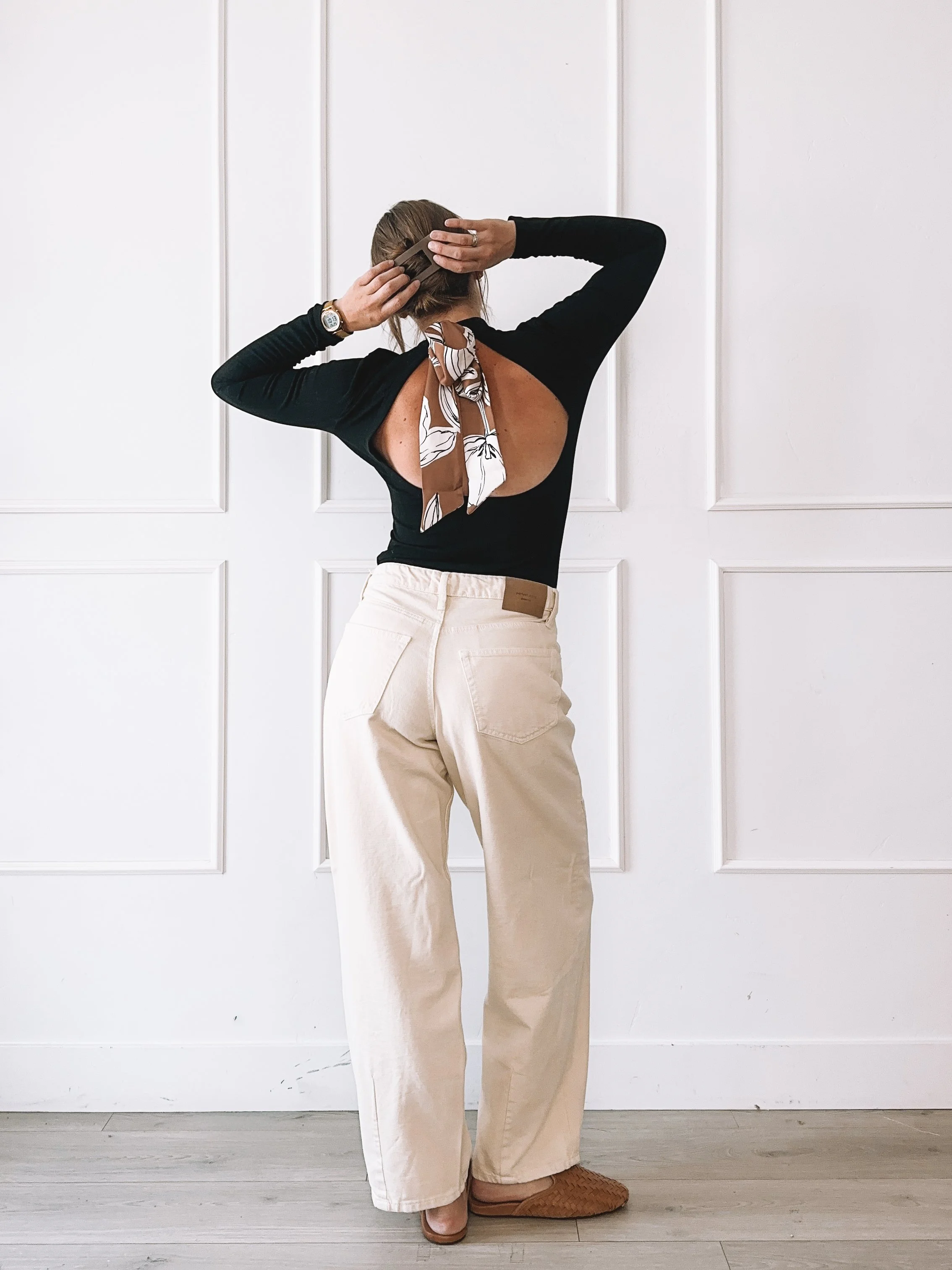 Black cutout top and cream wide leg jeans fall outfit