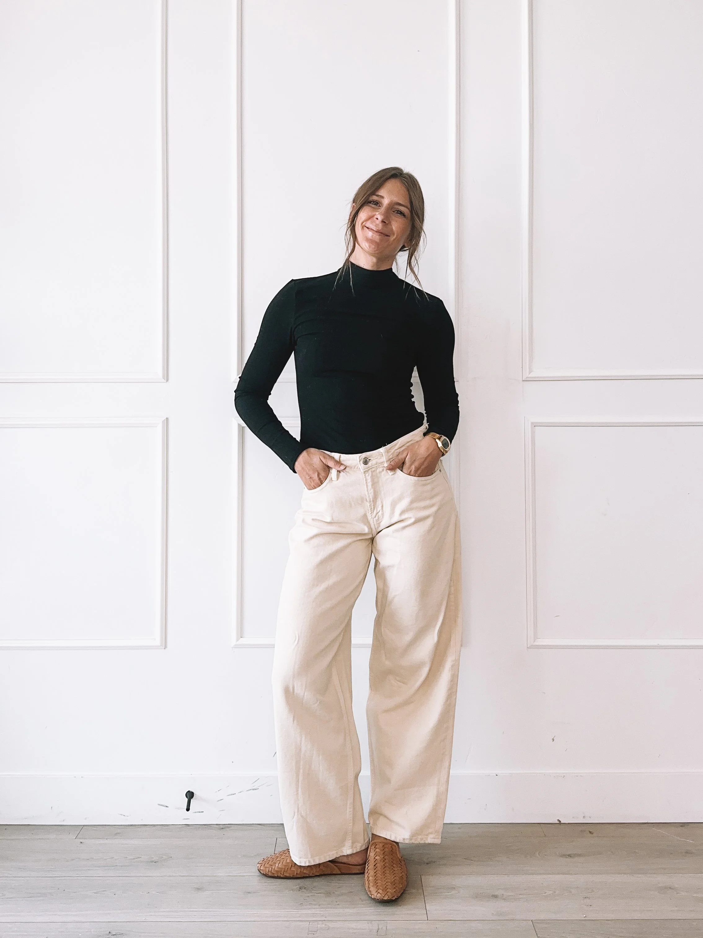Black cutout top and cream wide leg jeans fall outfit