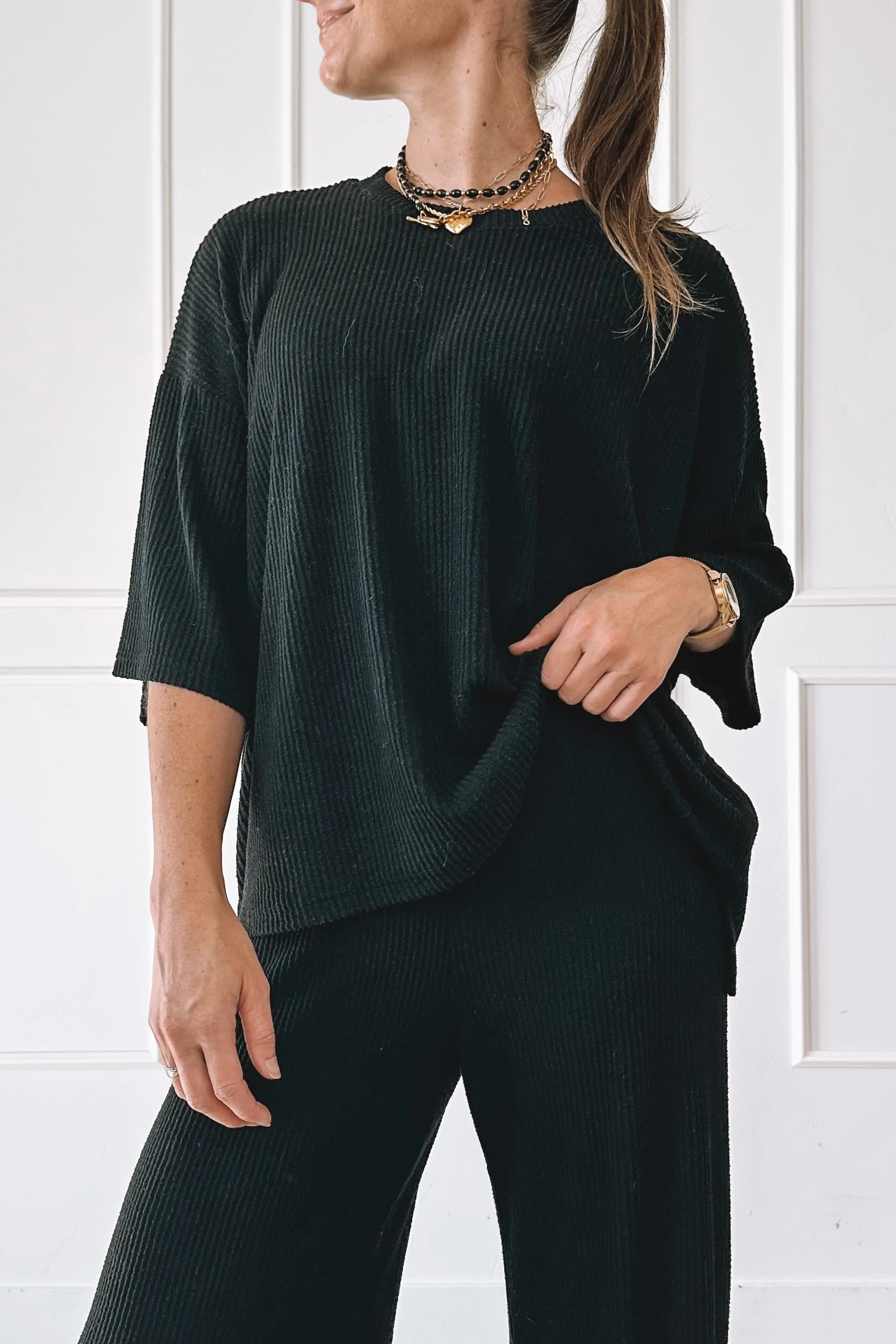 Layered Gold Necklaces With A Black Top