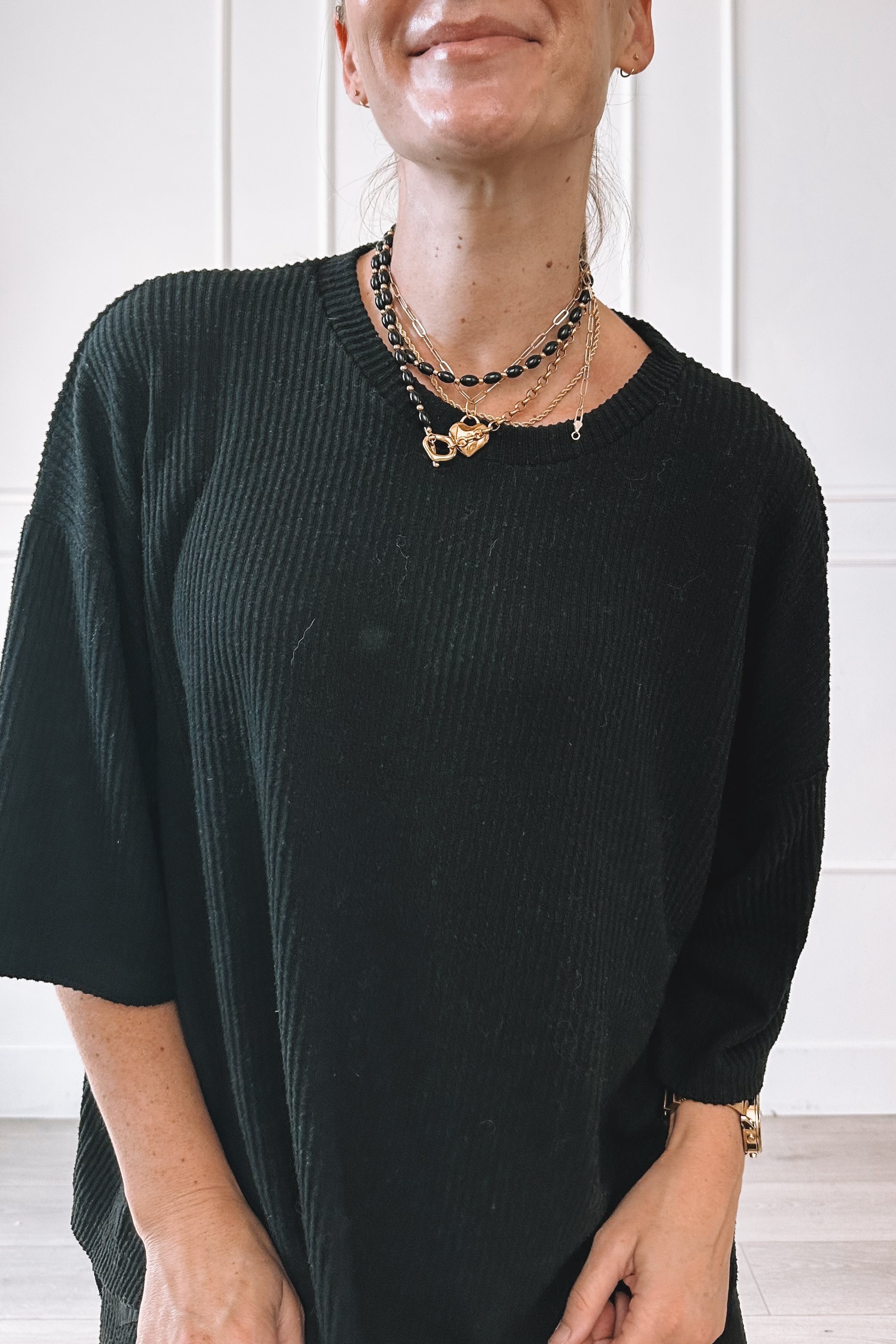 Layered Gold Necklaces With A Black Top