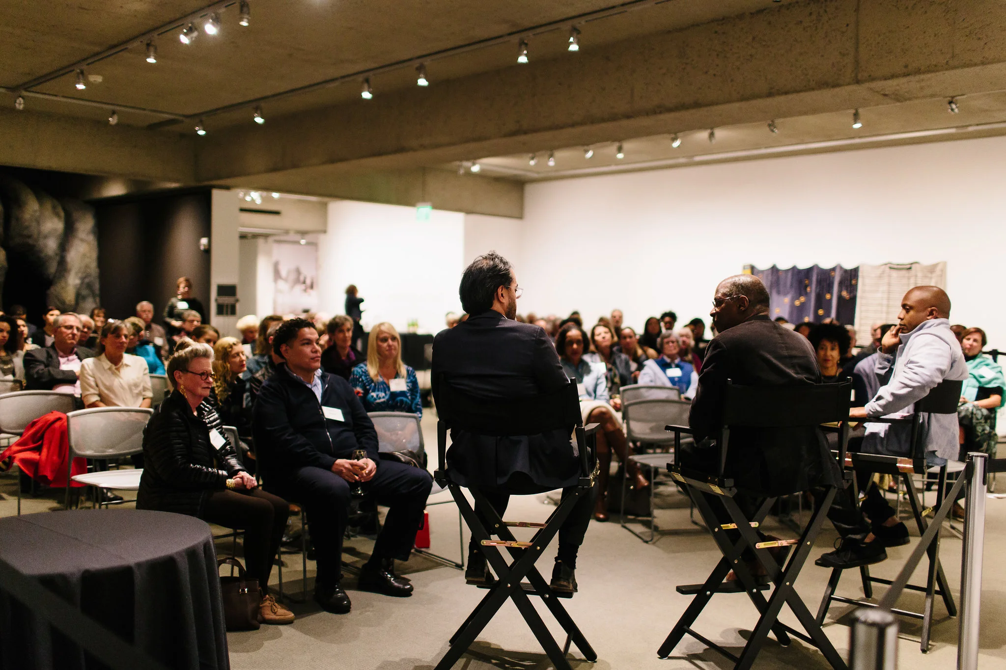 Rene de Guzman moderates a conversation between artists Chris Johnson and Hank Willis Thomas at the Question Bridge: Black Males Donor event in February of 2018. Photo: Clara Rice . Courtesy of Oakland Museum of California .