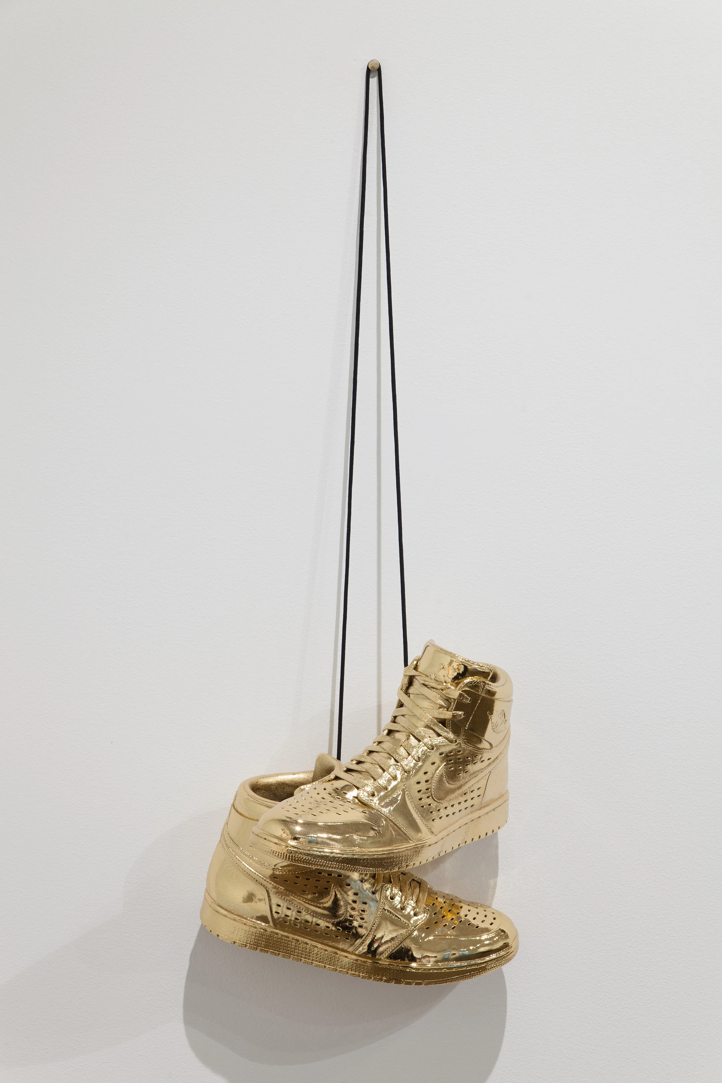 Kendell Carter, Effigy for a New Normalcy VII , 2017. 14k gold plated, bronzed Air Jordans. Photo courtesy of Michael DeFilippo. From upcoming exhibition RESPECT: Hip-Hop Style & Wisdom .