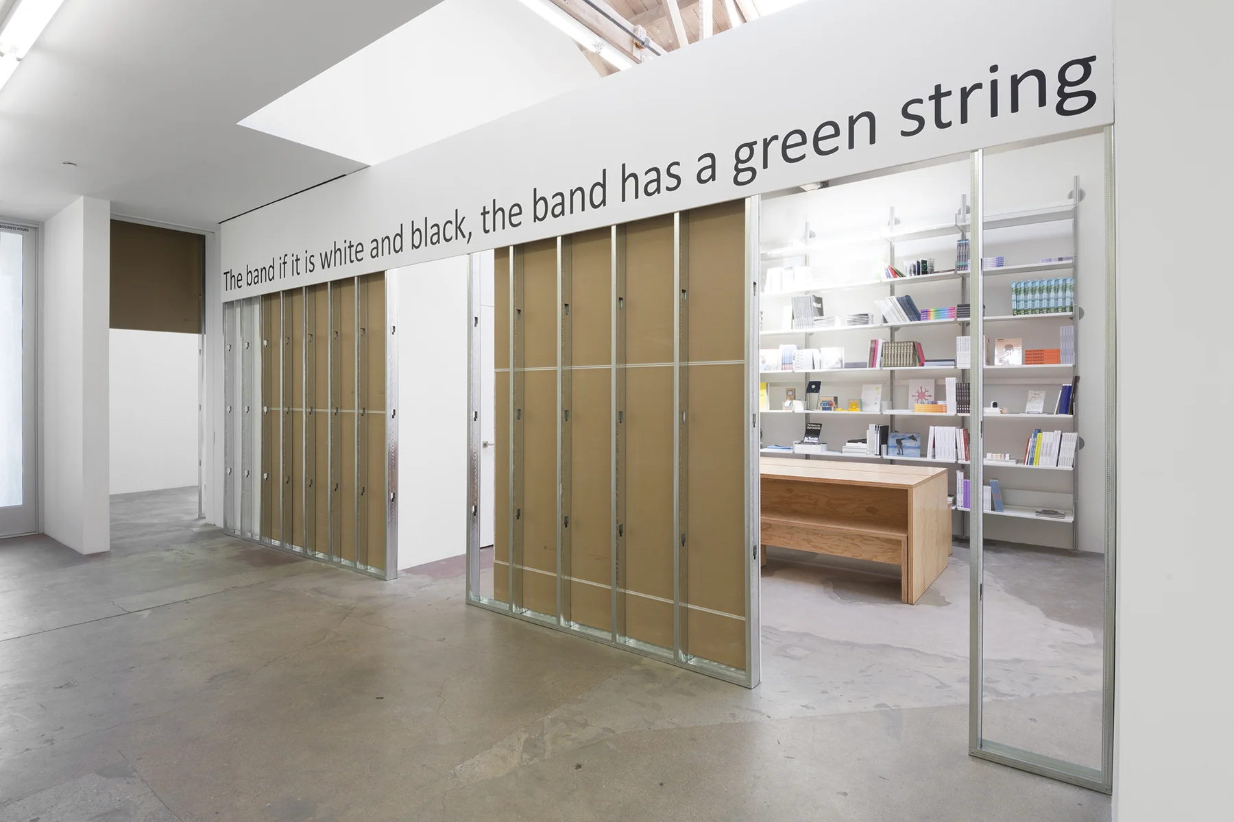 the band if it is white and black the band has a green string, 2019, found text, matte black vinyl, dimensions variable, Edition of 2. Courtesy the artist and Tanya Bonakdar Gallery, New York / Los Angeles
