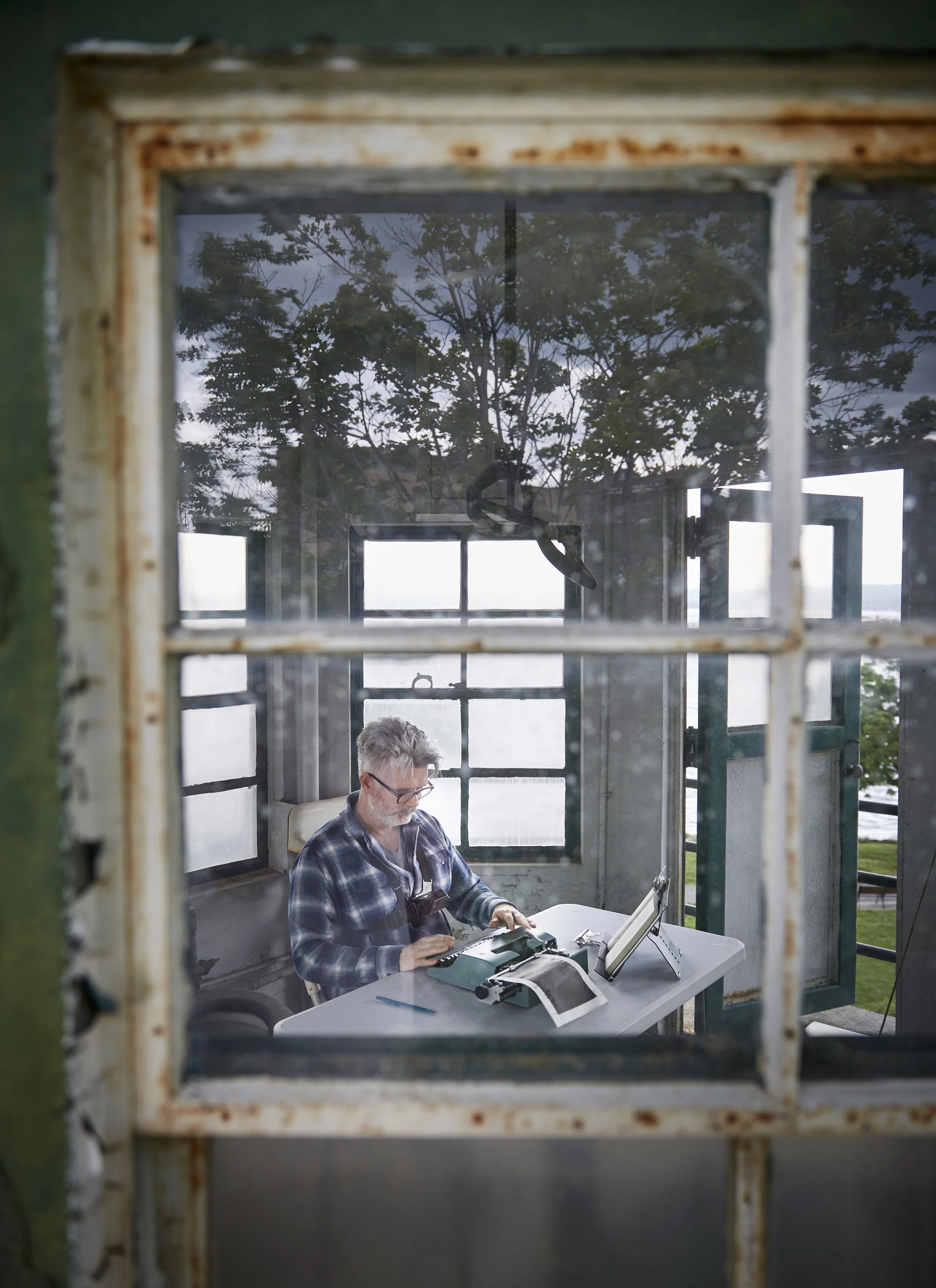 Tim Youd retyping John Cheever’s ‘Falconer’; 211 pages typed on an Olivetti Lettera 32 (decommissioned guard tower at Sing Sing Prison, Ossining, NY, June 2018). Photo credit: John Muggenborg.