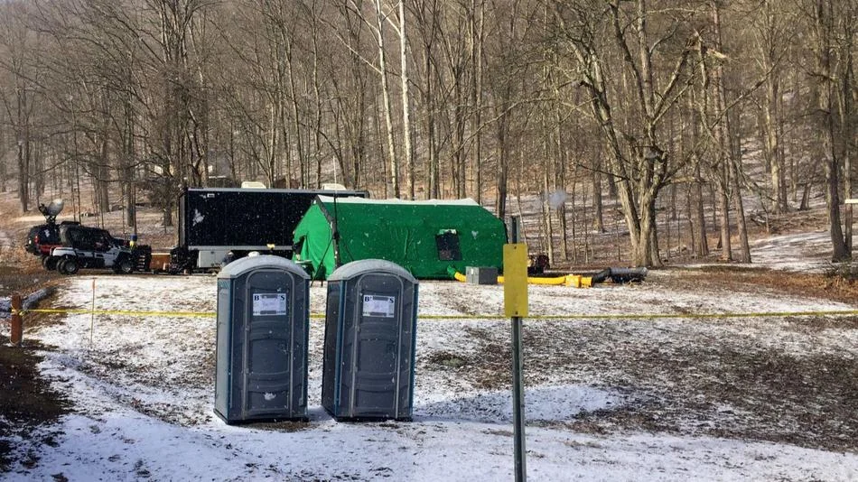 In this March 13, 2018 photo, FBI agents and representatives of the Pennsylvania Department of Conservation and Natural Resources set up a base off Route 555 in Benezette Township, Elk County, Pa., at a site where treasure hunters say Civil War-era gold is buried. (Katie Weidenboerner / AP)