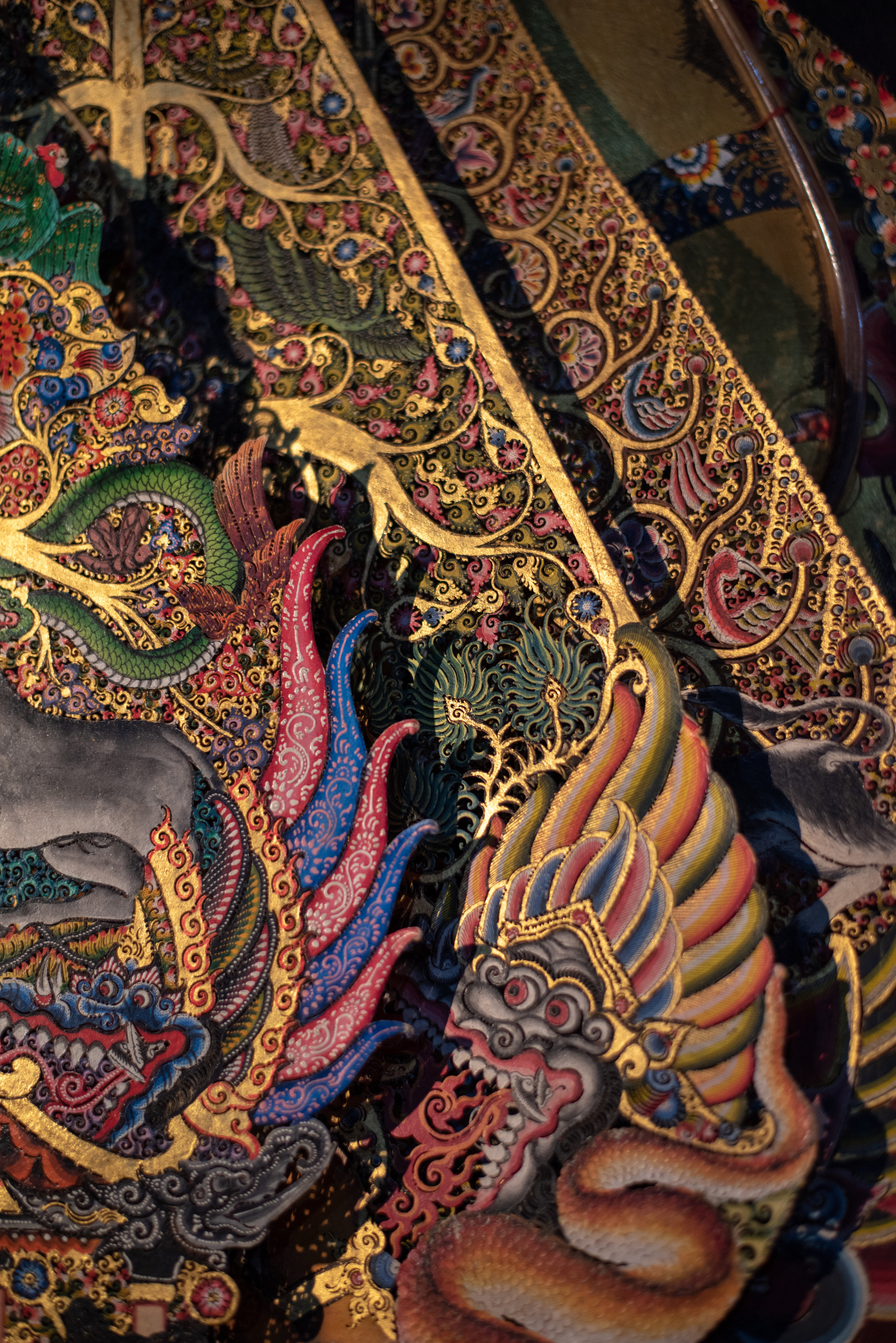 Ornate hand-painted shadow puppets known as Gunungan