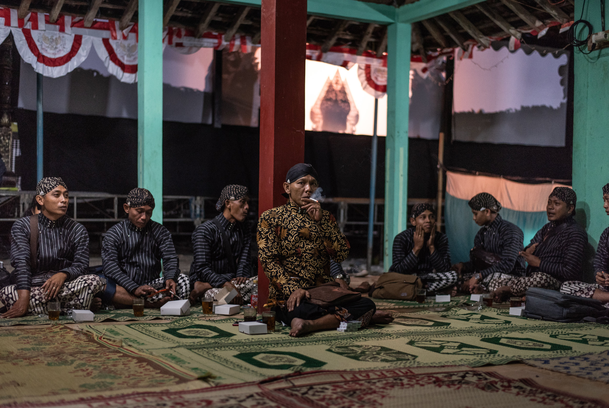 Ki Senu Nugruho sits back stage with his orchestra before they begin their performance.