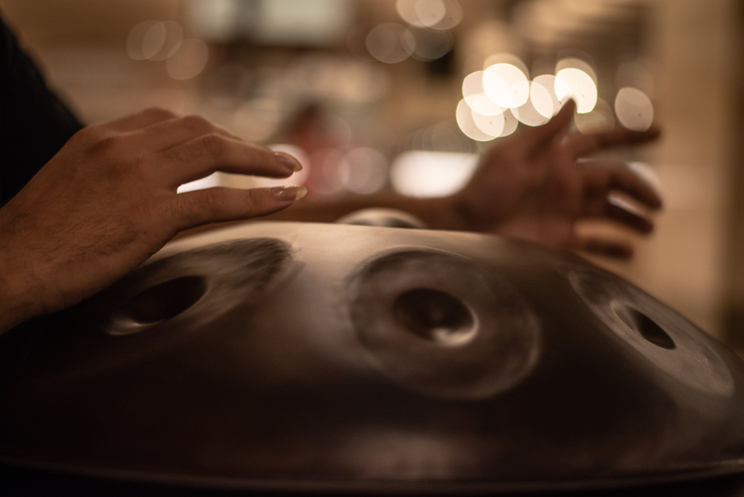  The Hang, a class of steel drum known as a hand pan, is played by gently striking the grooved areas with fingers. Each section is precisely tuned to produce a specific note.  