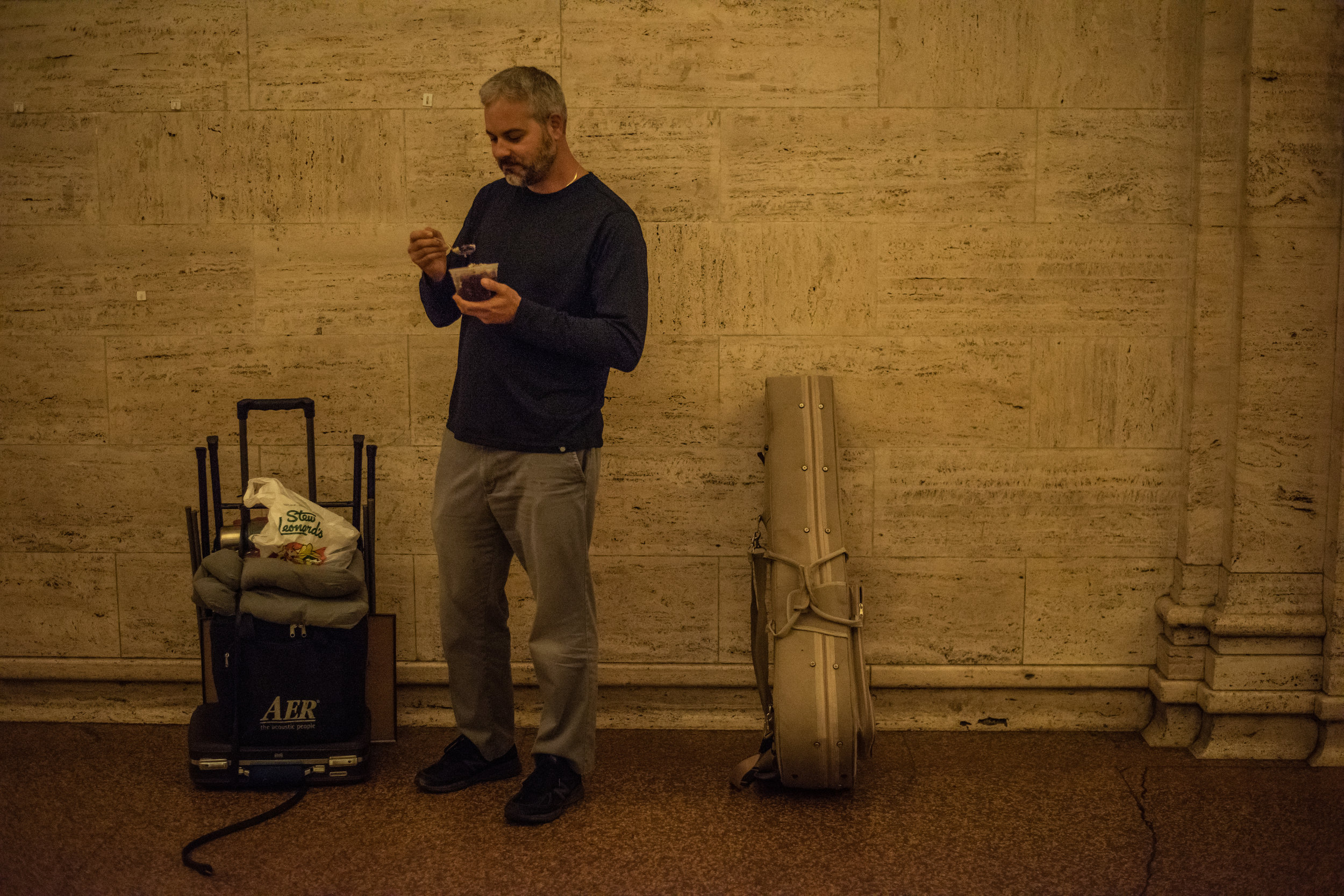 With little time to spare, Glenn indulges in a quick standing breakfast.