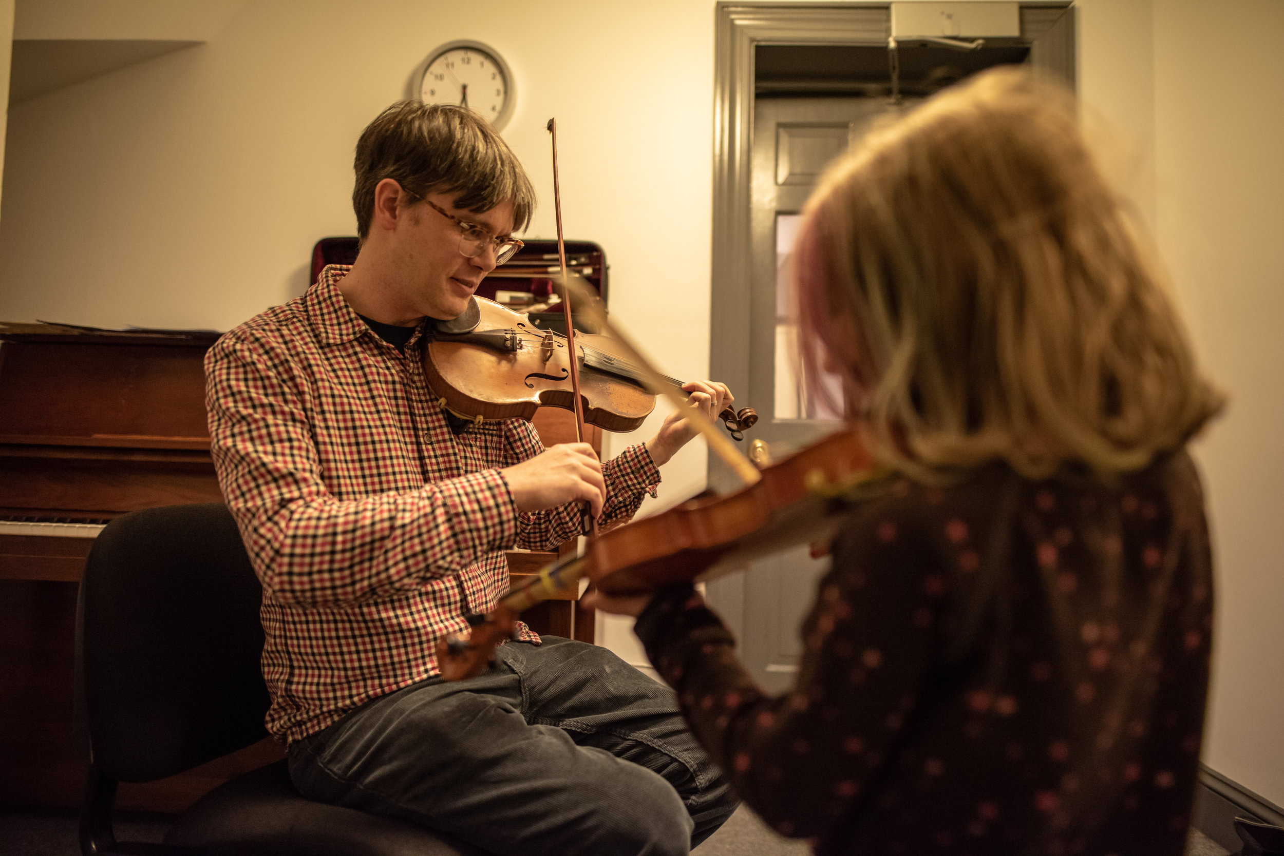  Here Tom provides violin lessons to students of all ages. 