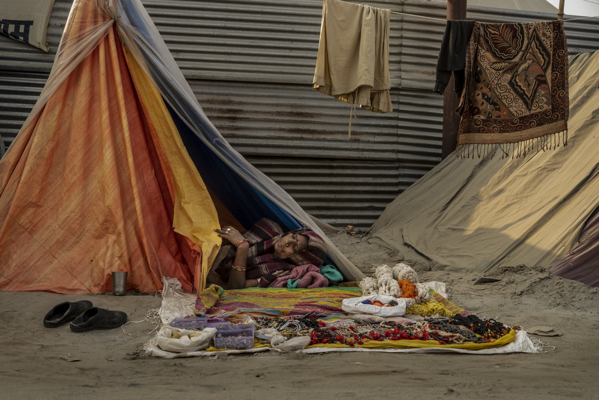 Women sleeps in here roadside tent as she sells wares.