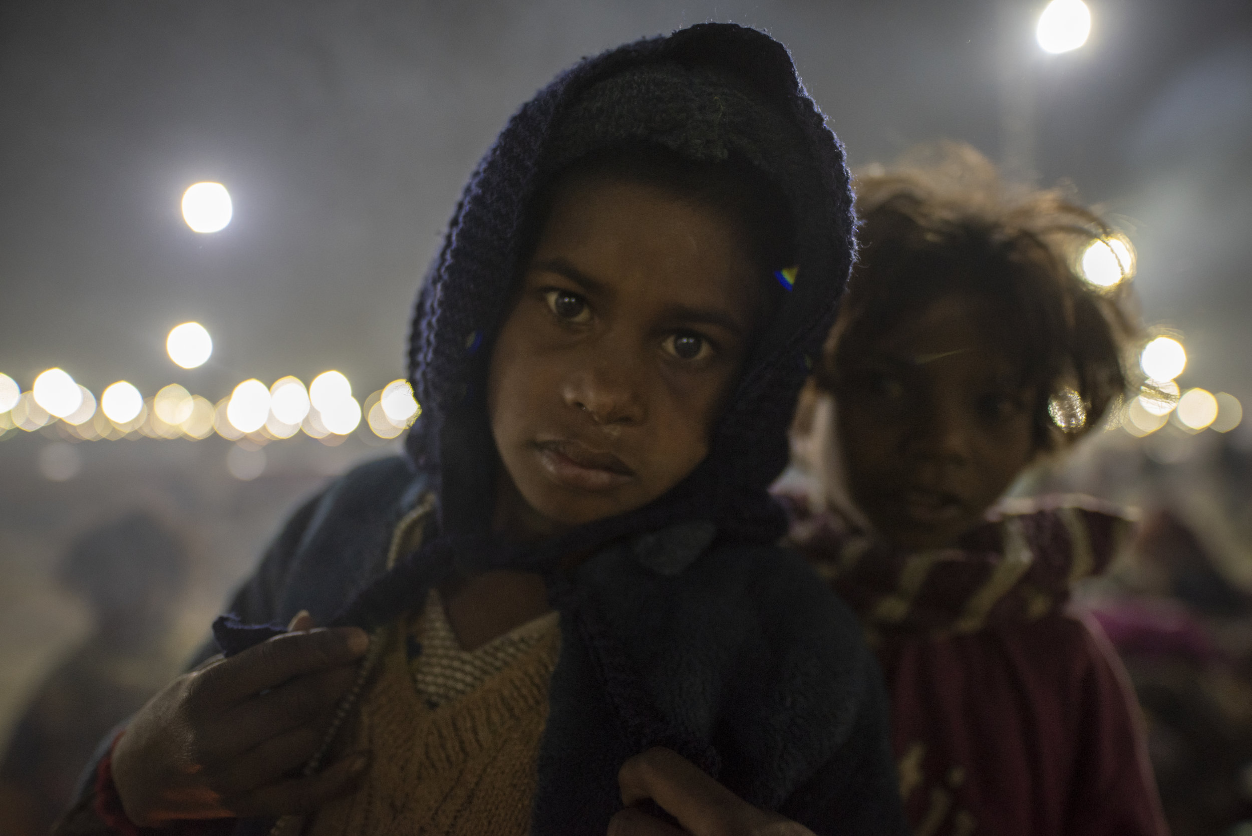 Two young girls await their morning trek to the Ganges