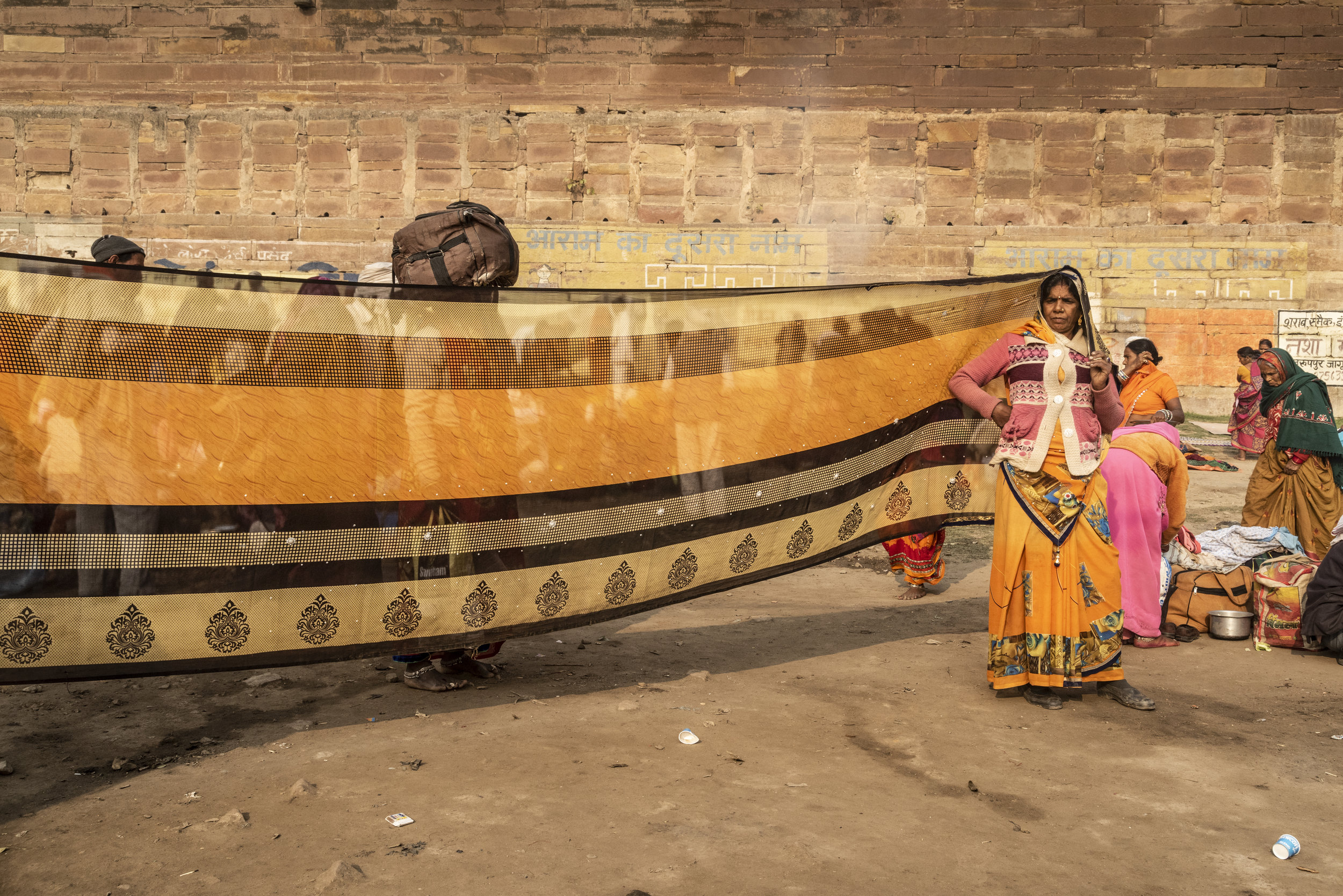  A woman dries her bright orange saree in the midday sun, likely after dipping it in the Ganges during her morning trip to Sangam. This strange yet beautiful occurrence became common place by the time I’d left the Kumbh. I will always remember these 