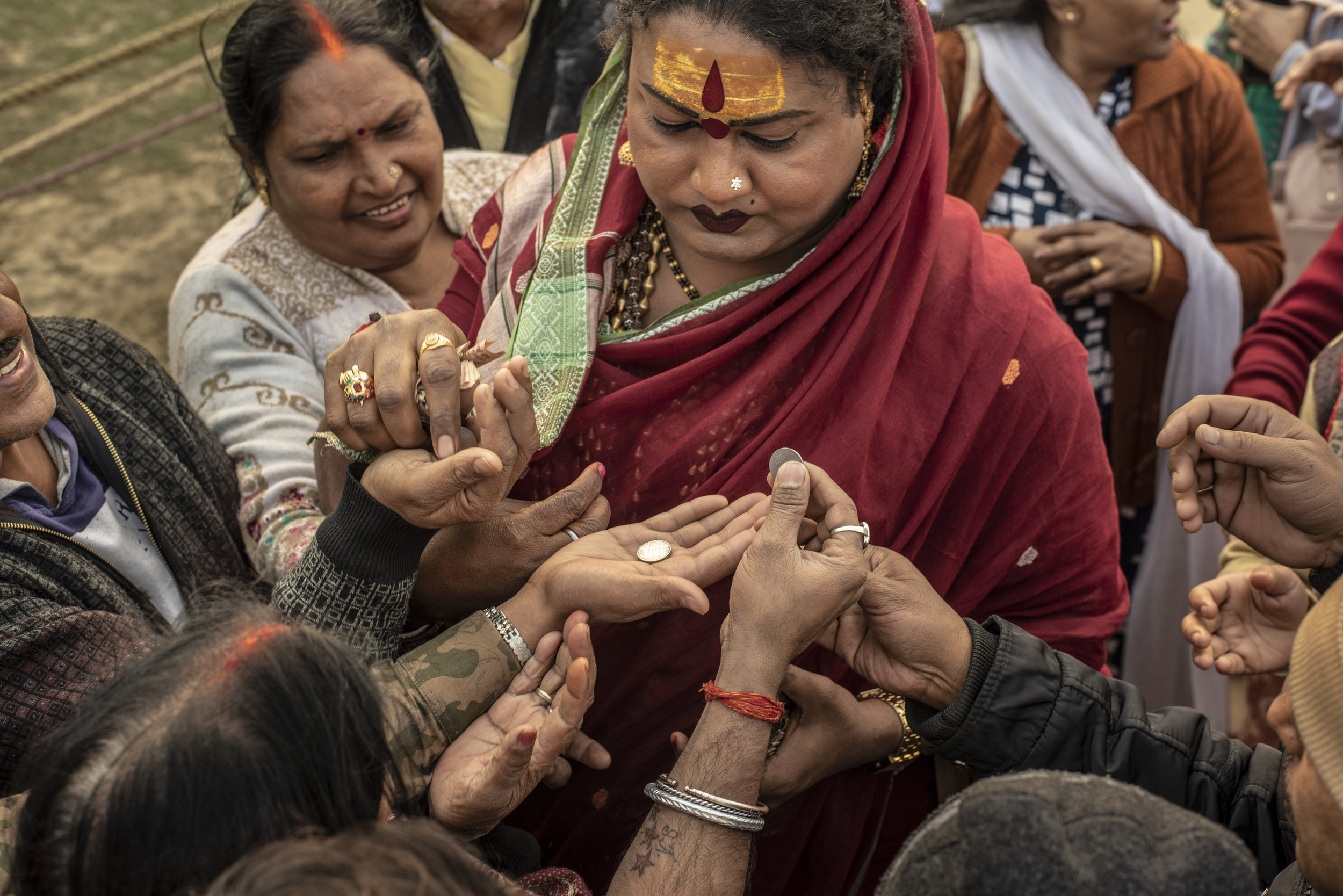 Mayuri Ma blesses coins and receives money offerings from followers.