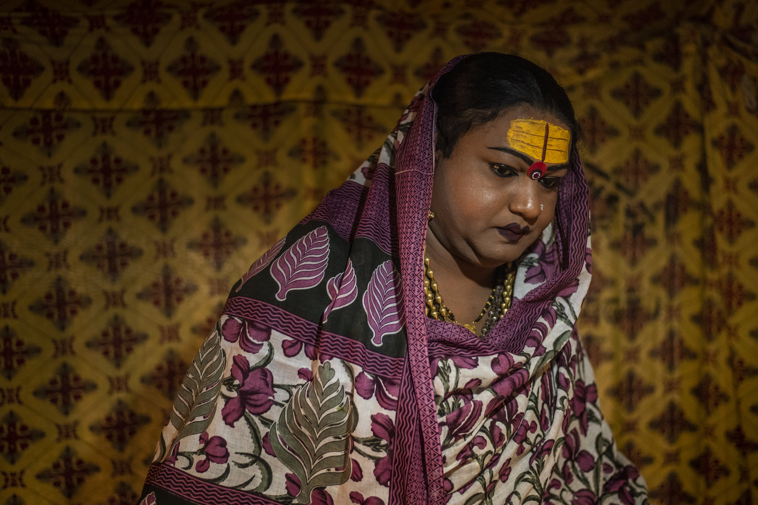  Mayuri Ma, a kinnar akada (transgender), prepares to leave her tent to give blessings to her followers. 