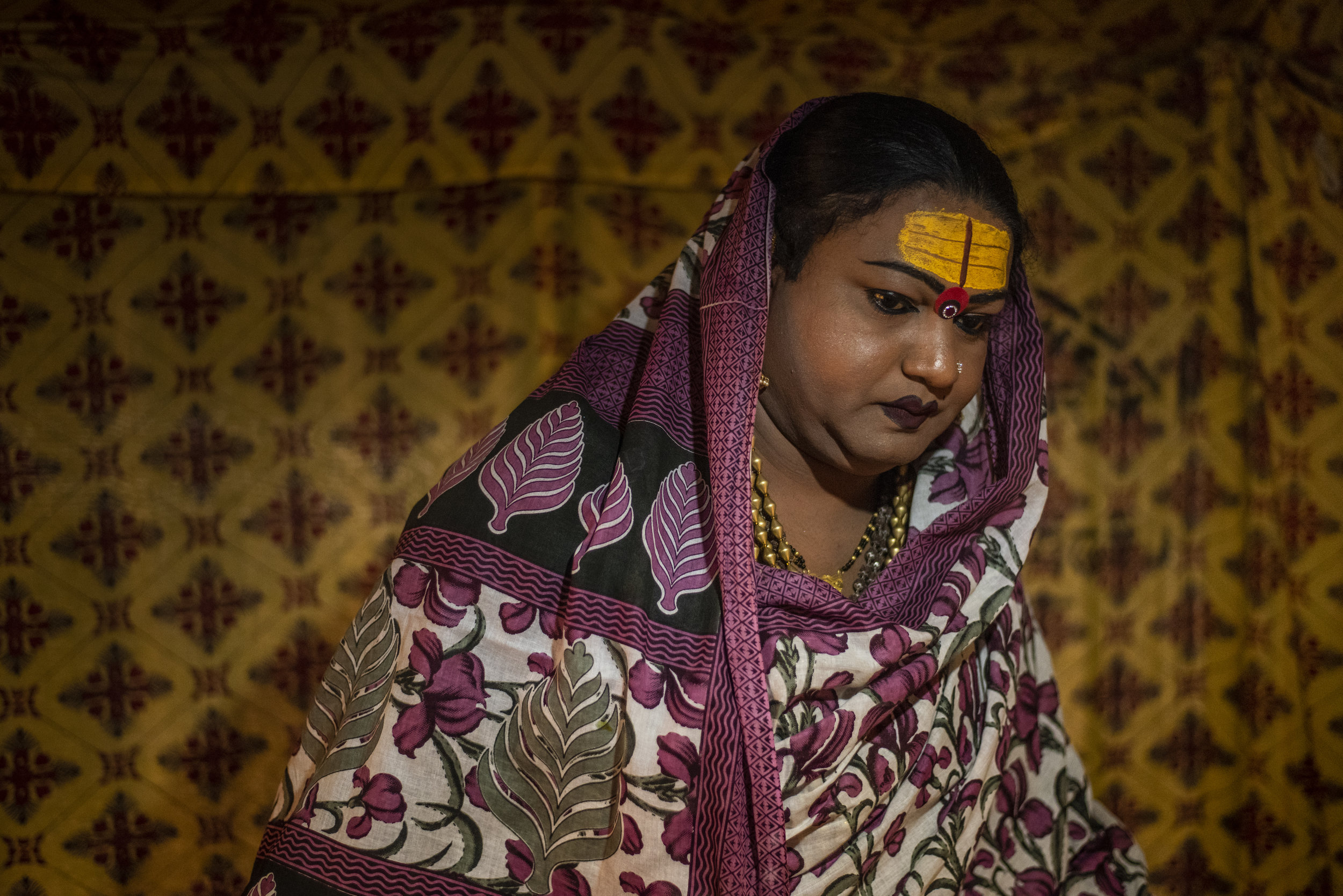 Mayuri Ma, a kinnar akada (transgender), prepares to leave her tent to give blessings to her followers.