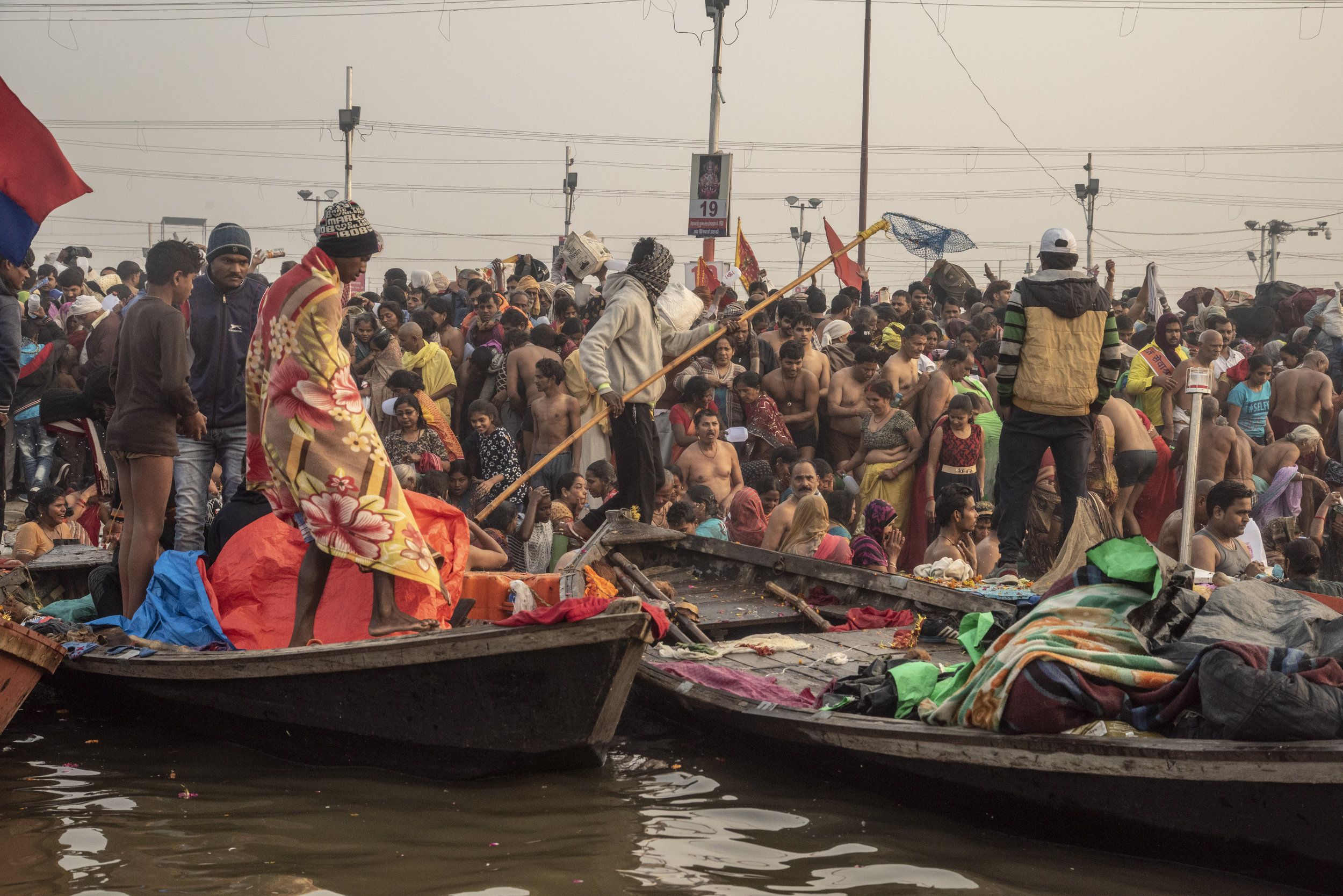  Boats line the shore as a mass of people gather to bathe in the ganges 