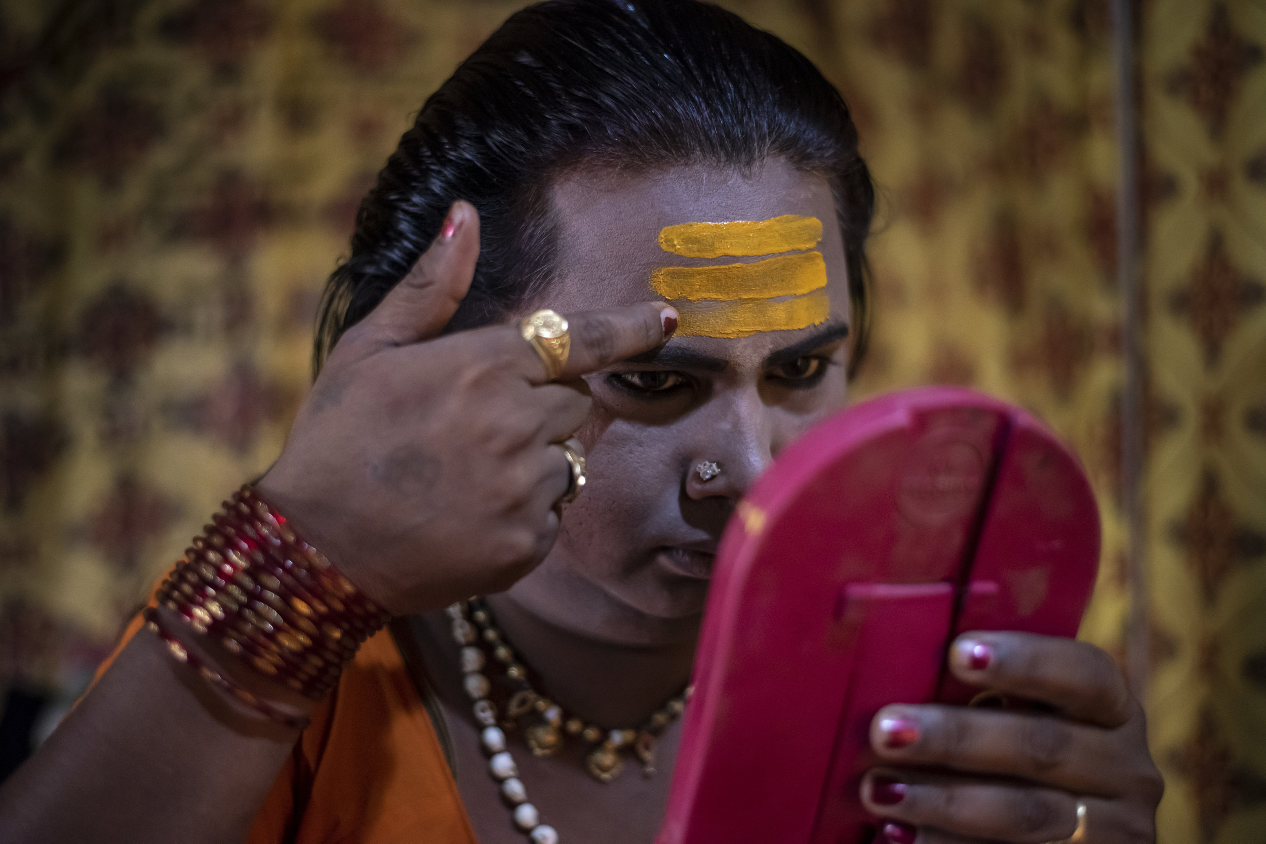  A Kinnar Akada (transgender) applies makeup  