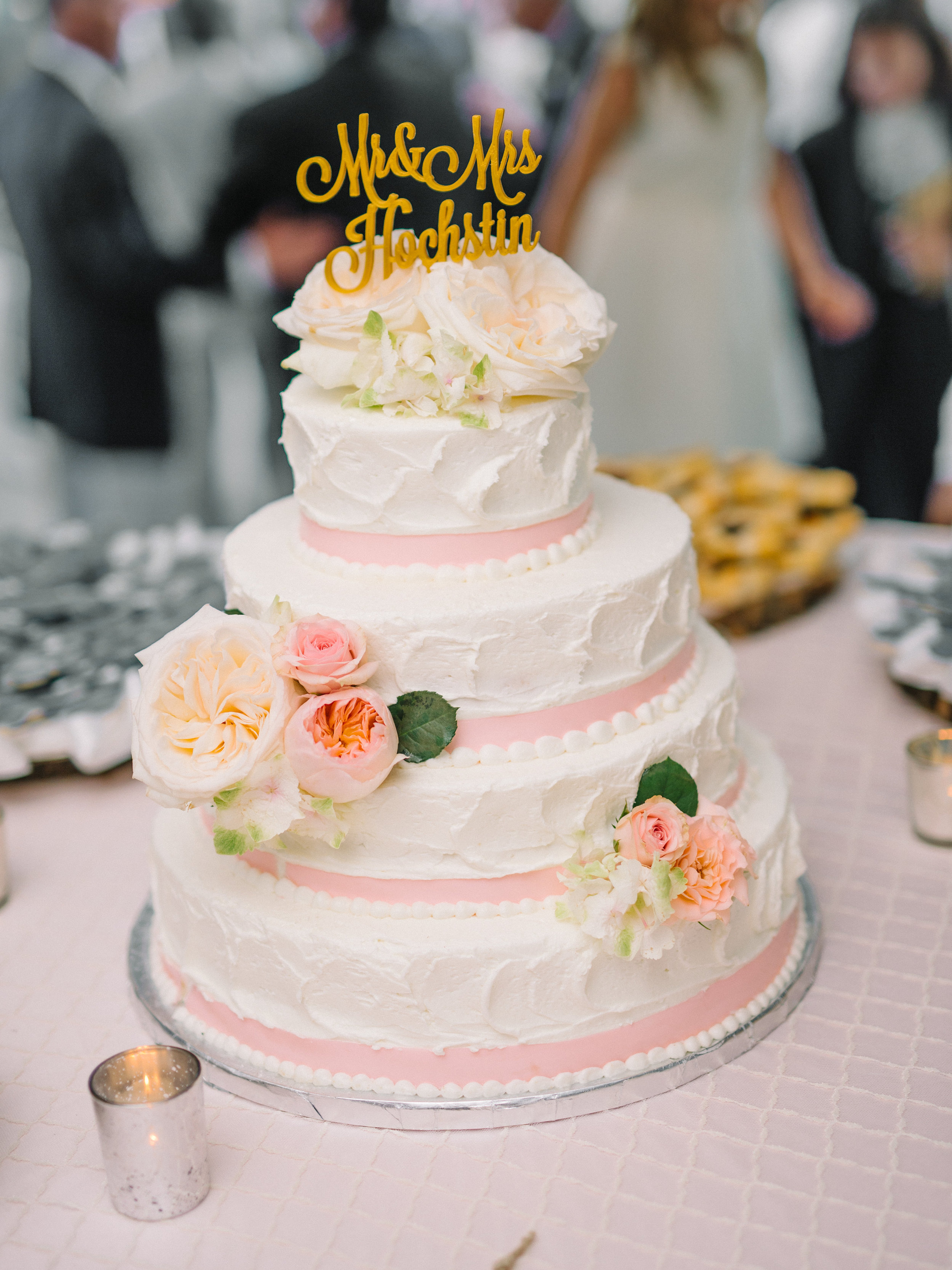 Tiered wedding cake with pink and gold accents