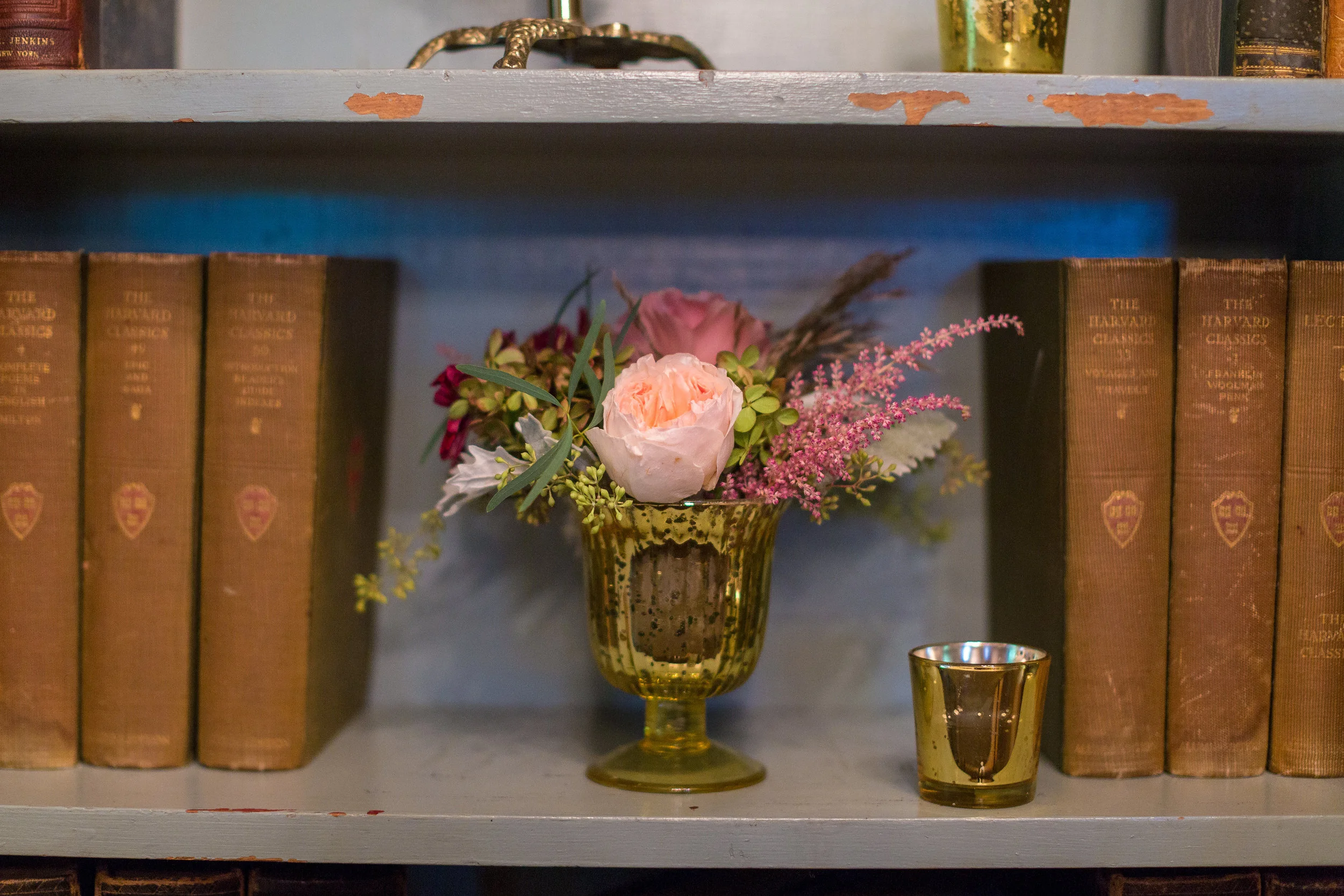 gold chalice decor with vintage books