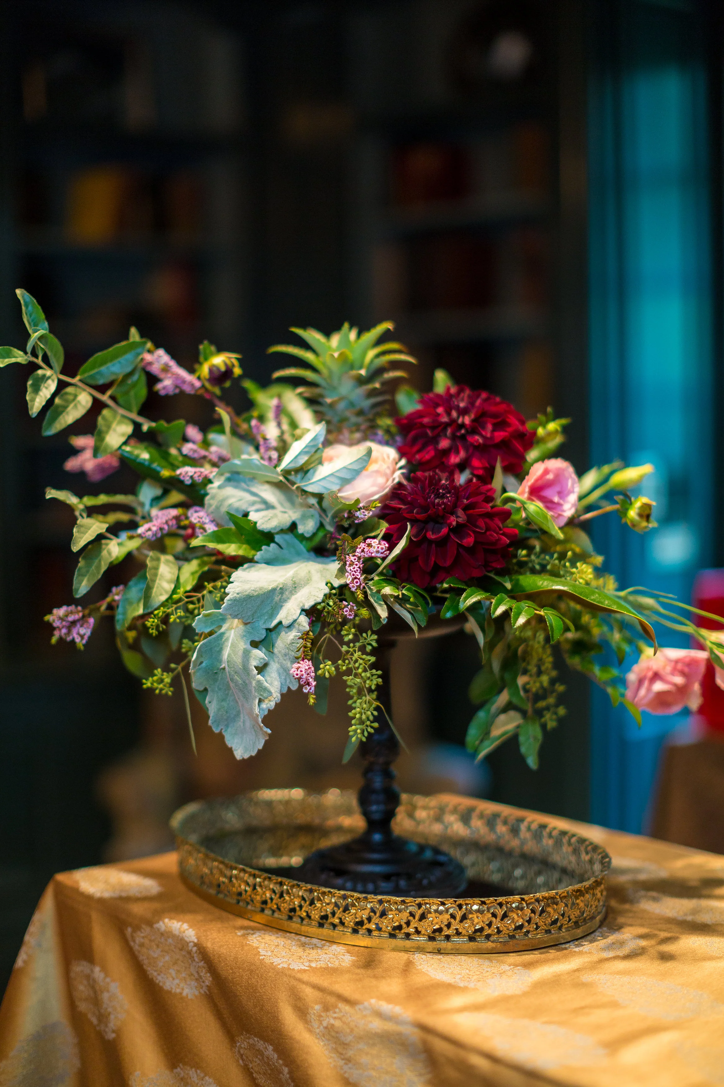 fall floral arrangement on black stand