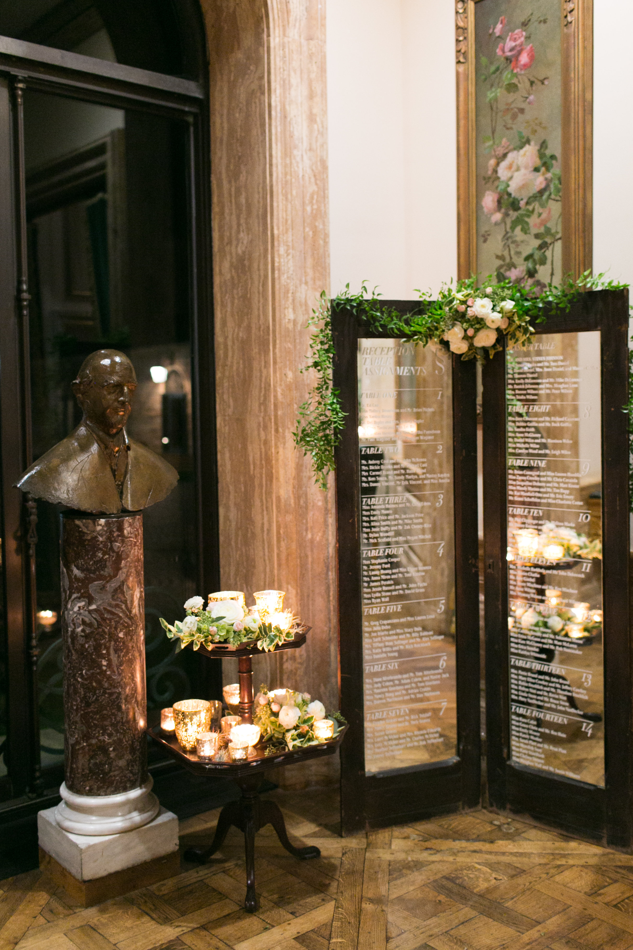 Rentals from our vintage furniture collection brought the table layout to life, with vinyl lettering set on our mirrored wooden doors. Our side table was filled with candles, greenery, roses and ranunculus to dress up the corner and create an inviting spot for guests to find their seating arrangement. 