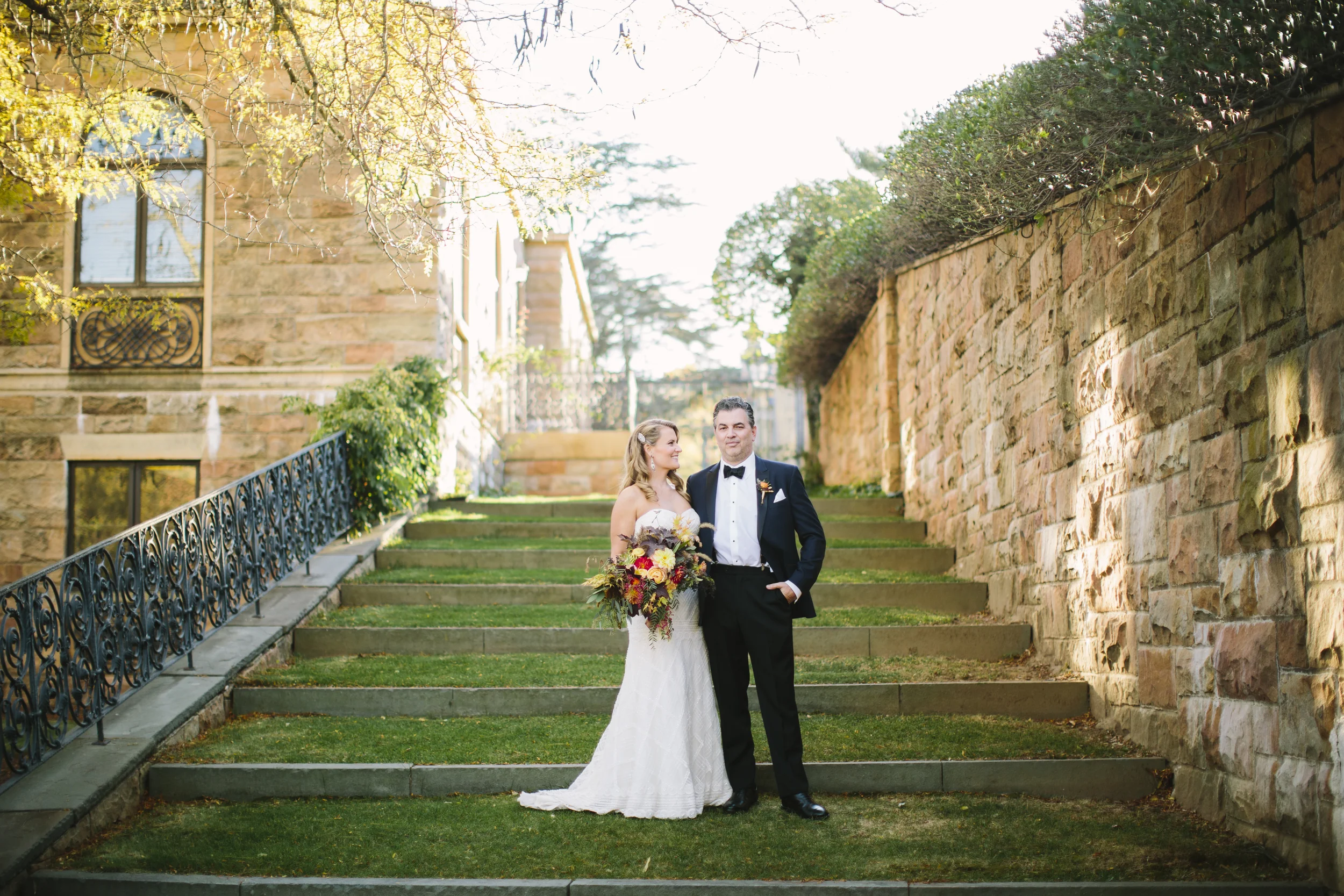 bride and groom posing in gardens