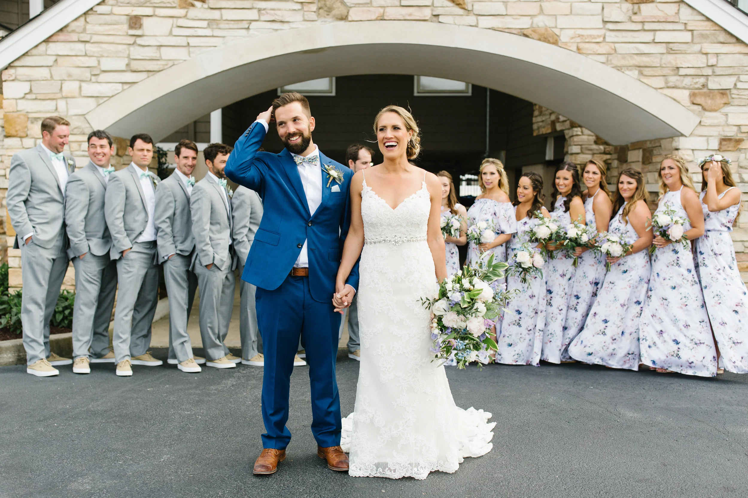 bridal party posing with spring bouquets