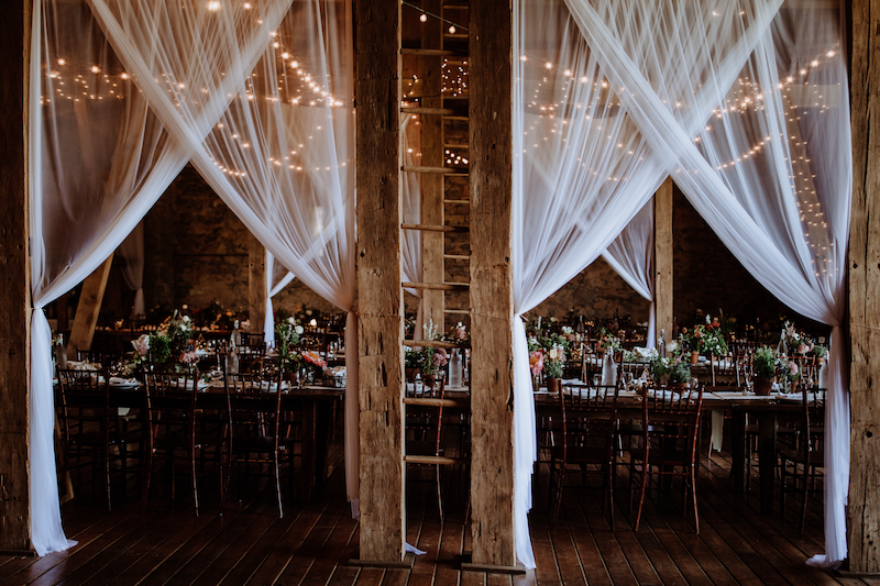 barn wedding with draping and lights